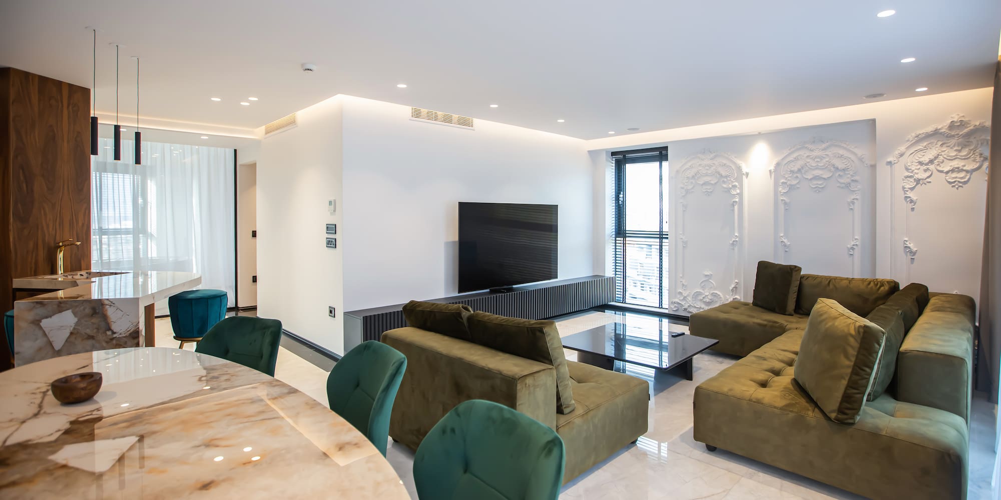 a living room with a table and couches