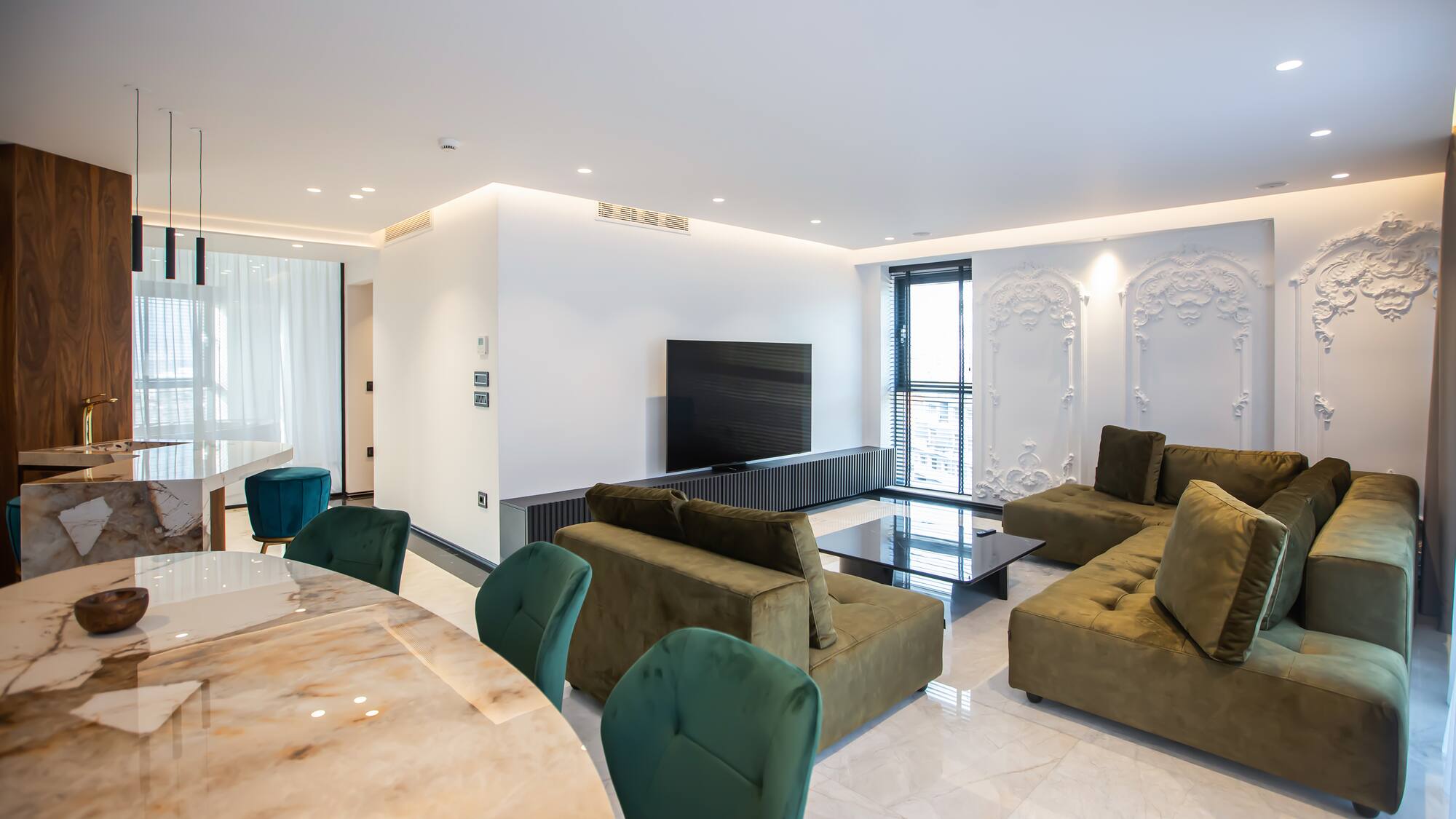 a living room with a table and couches