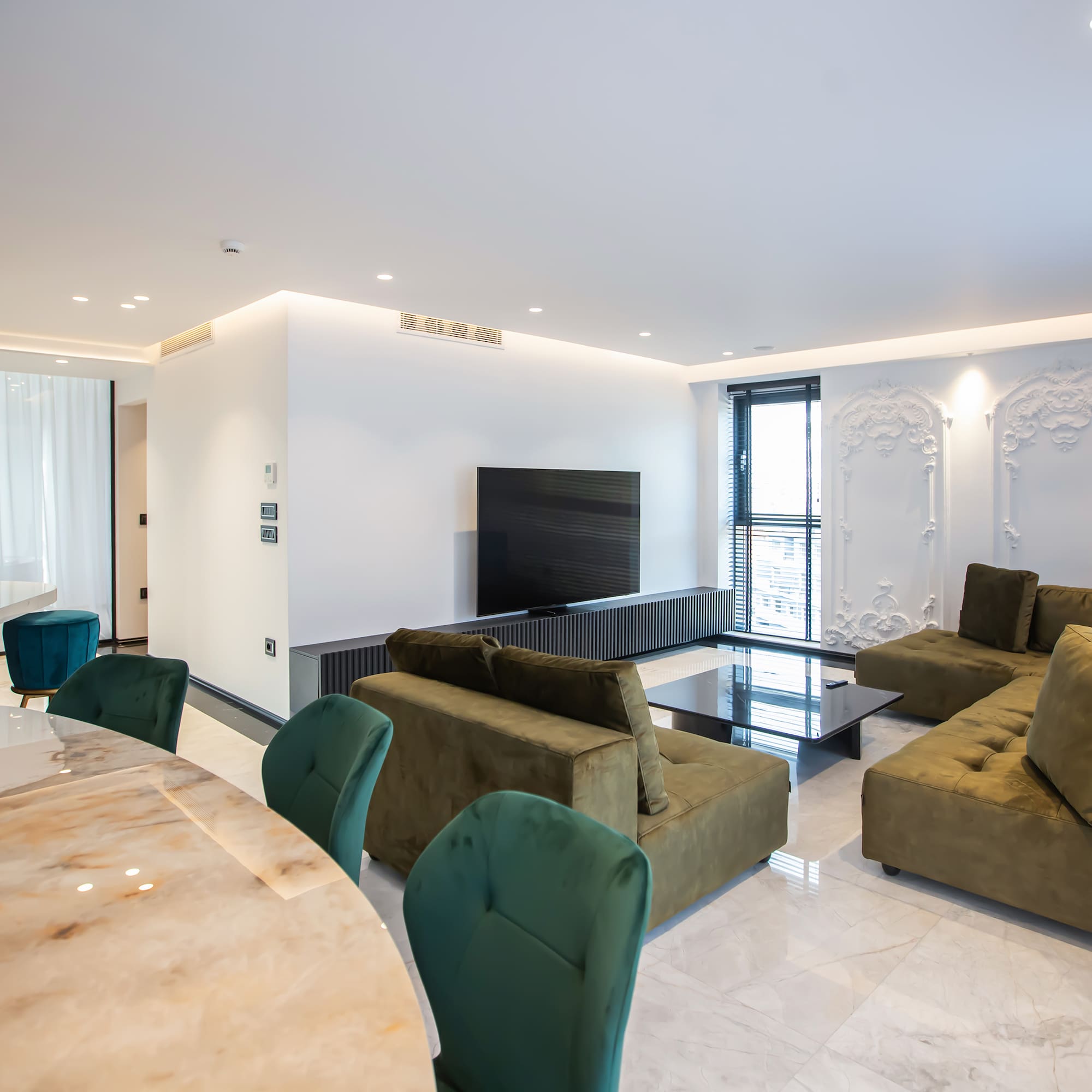 a living room with a table and couches