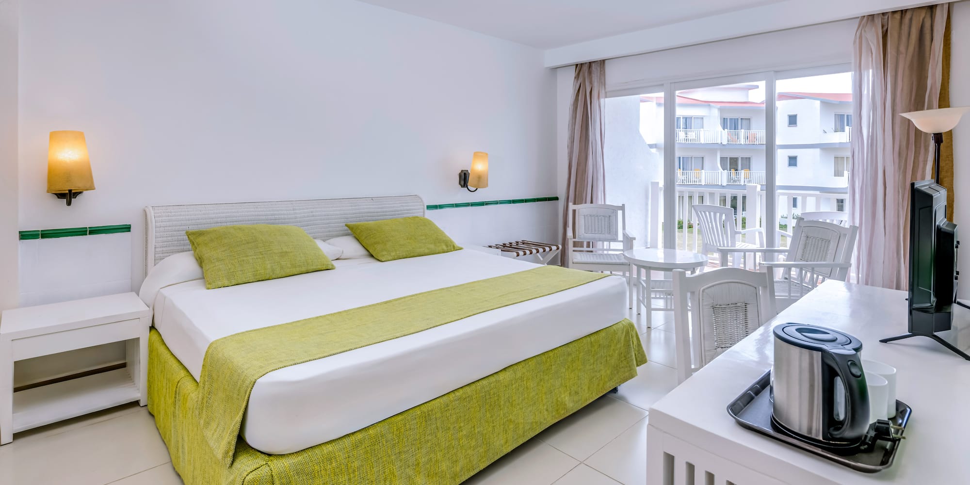 a room with a bed and a table and chairs