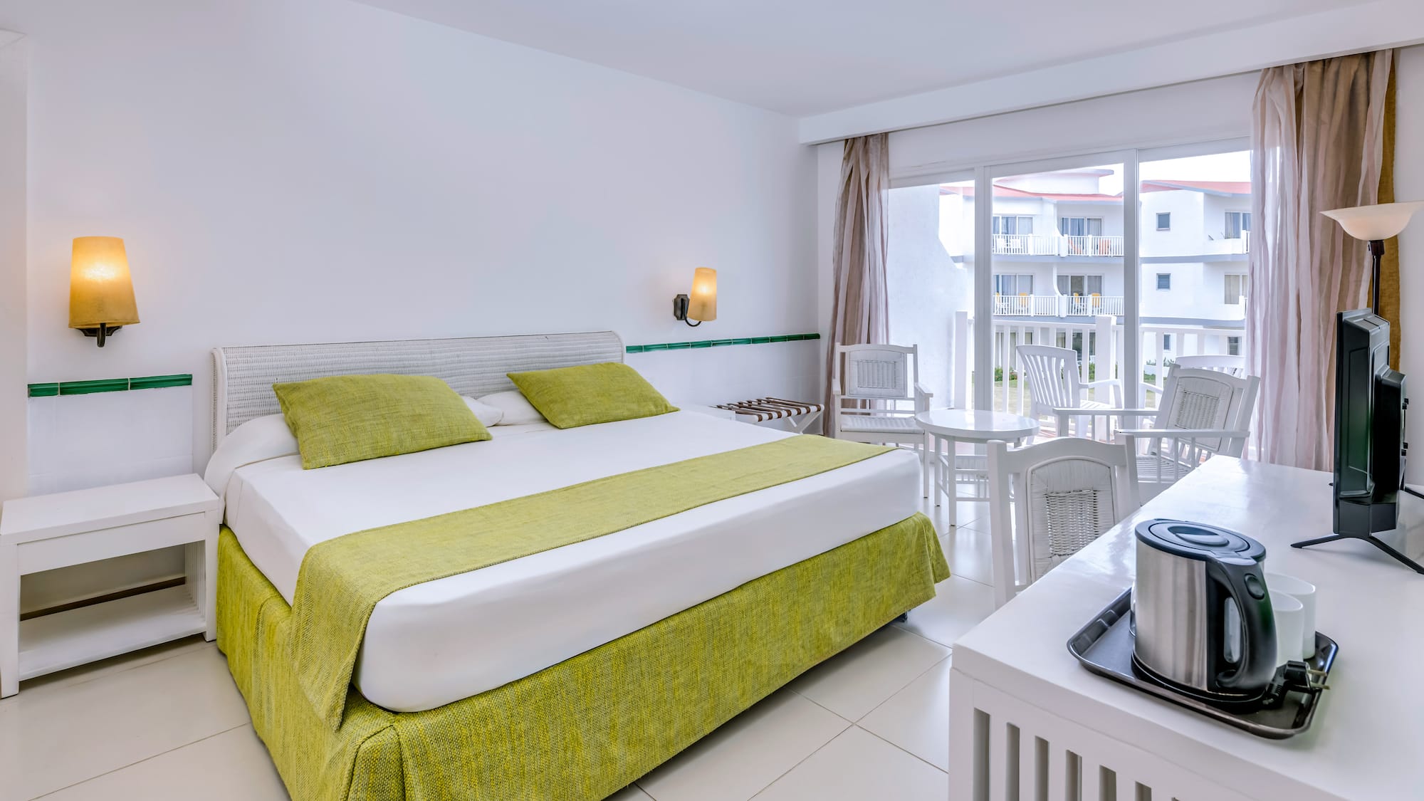 a room with a bed and a table and chairs