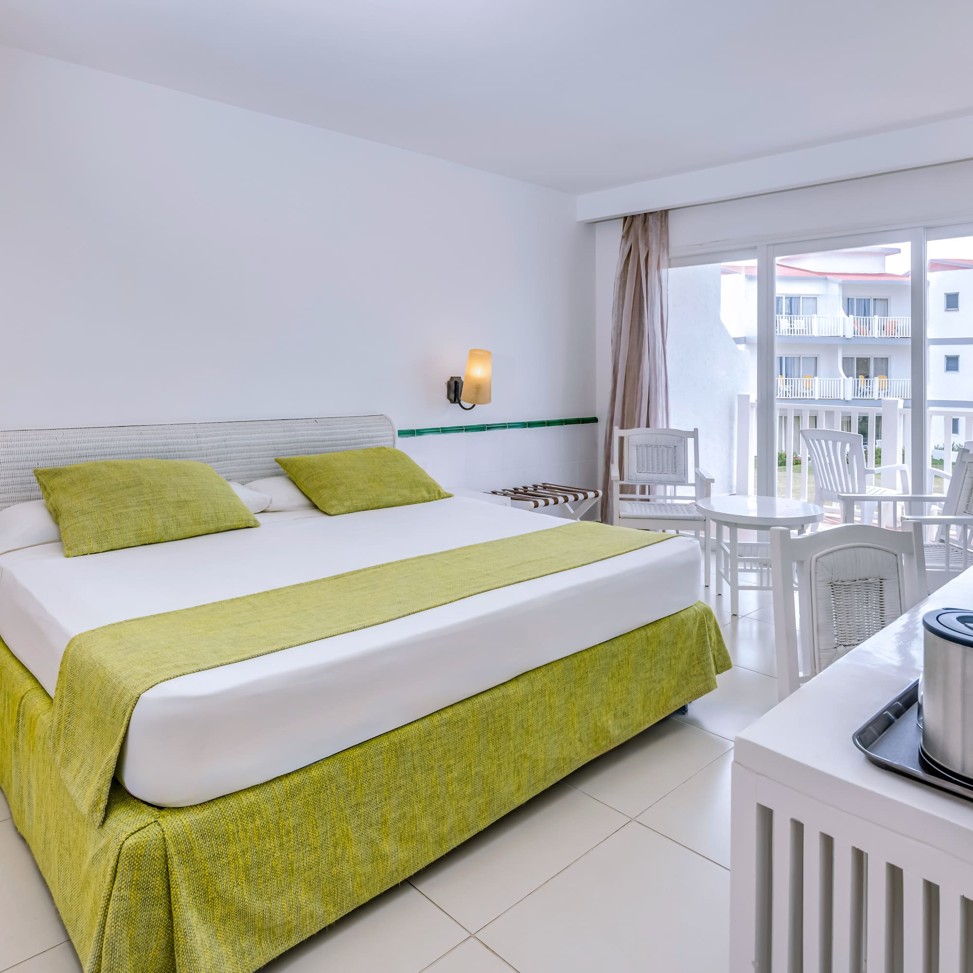 a room with a bed and a table and chairs