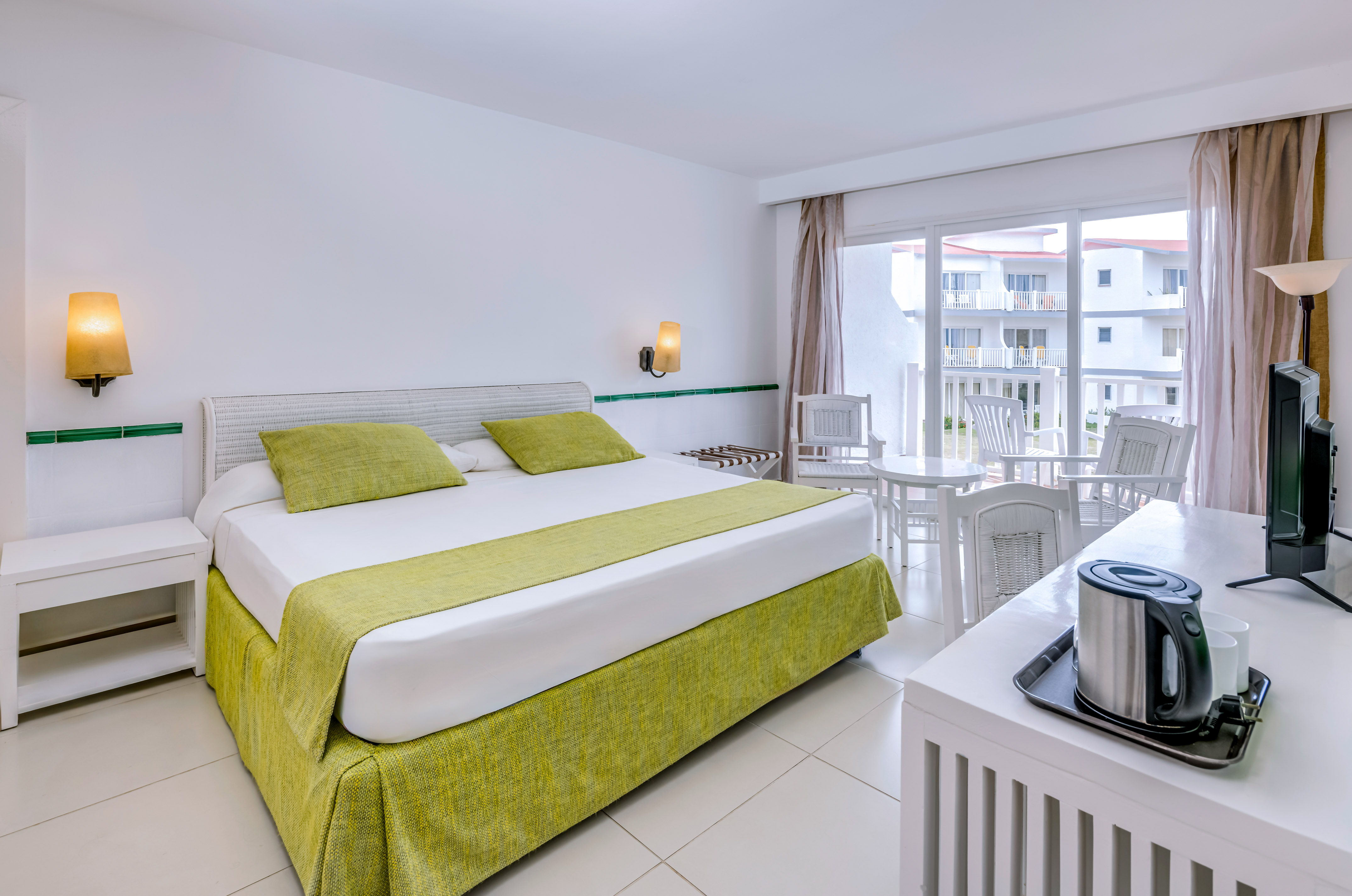 a room with a bed and a table and chairs