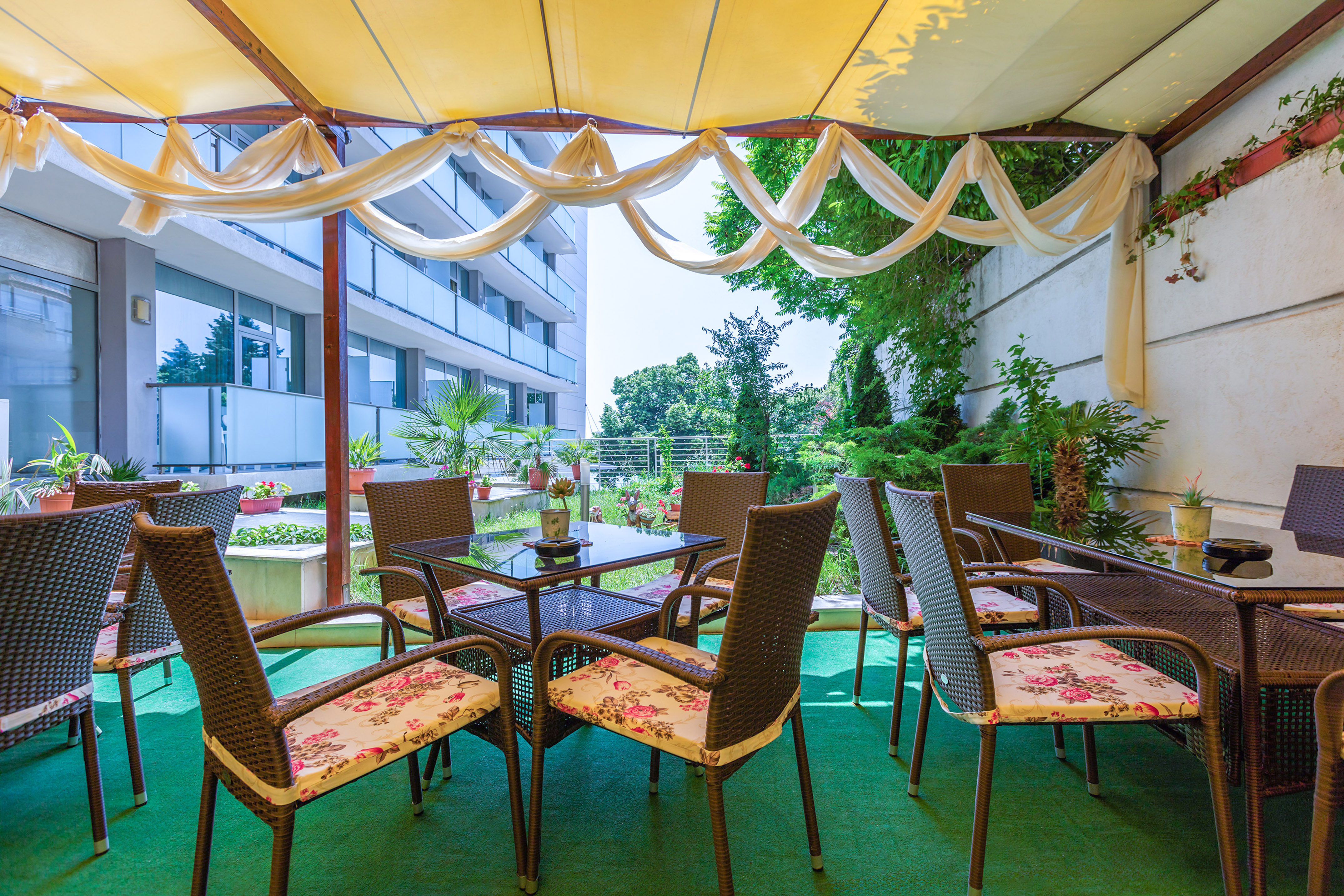 a patio area with chairs and tables