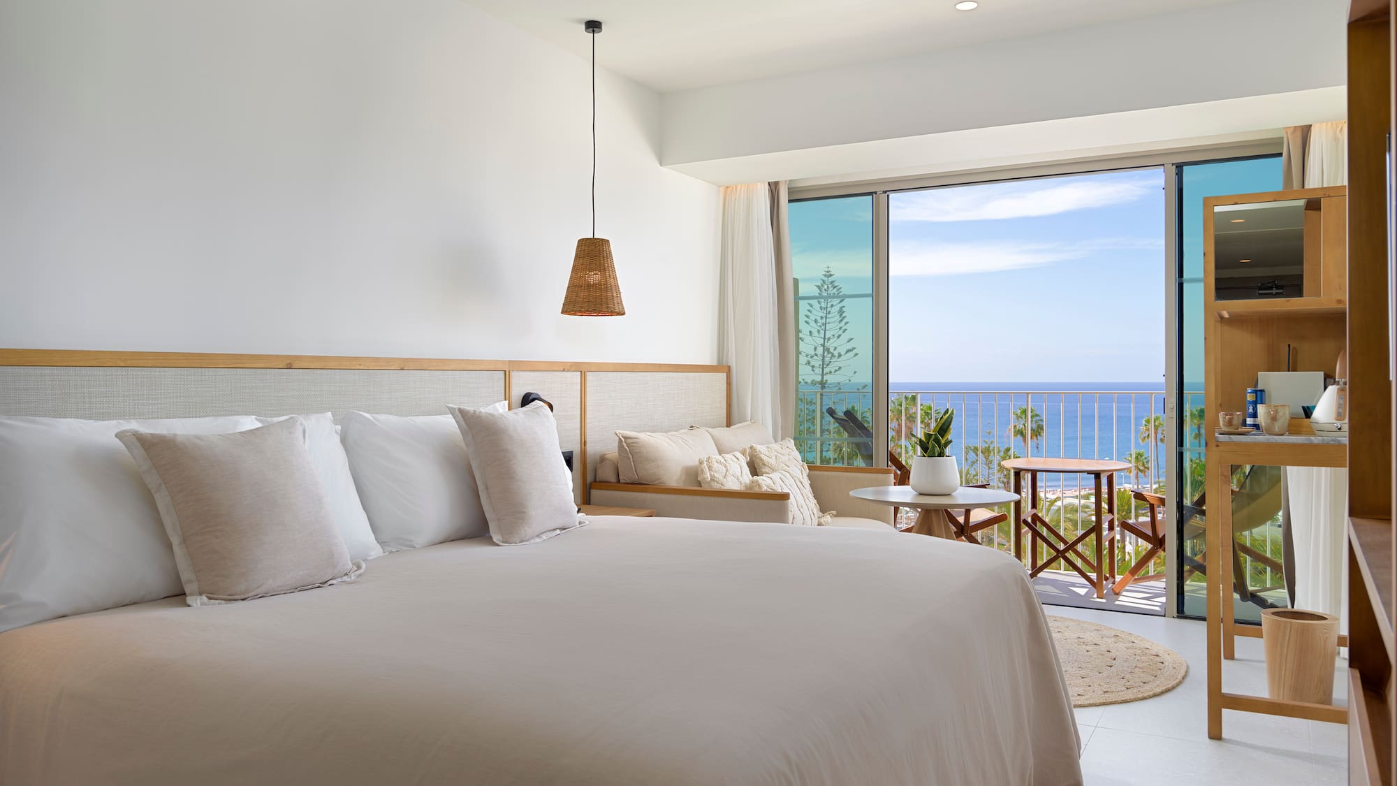 a bedroom with a large bed and a large window