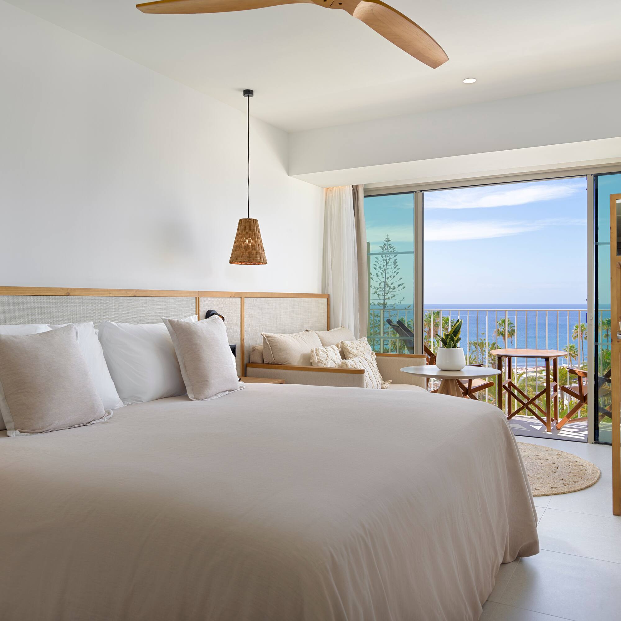 a bedroom with a large bed and a large window