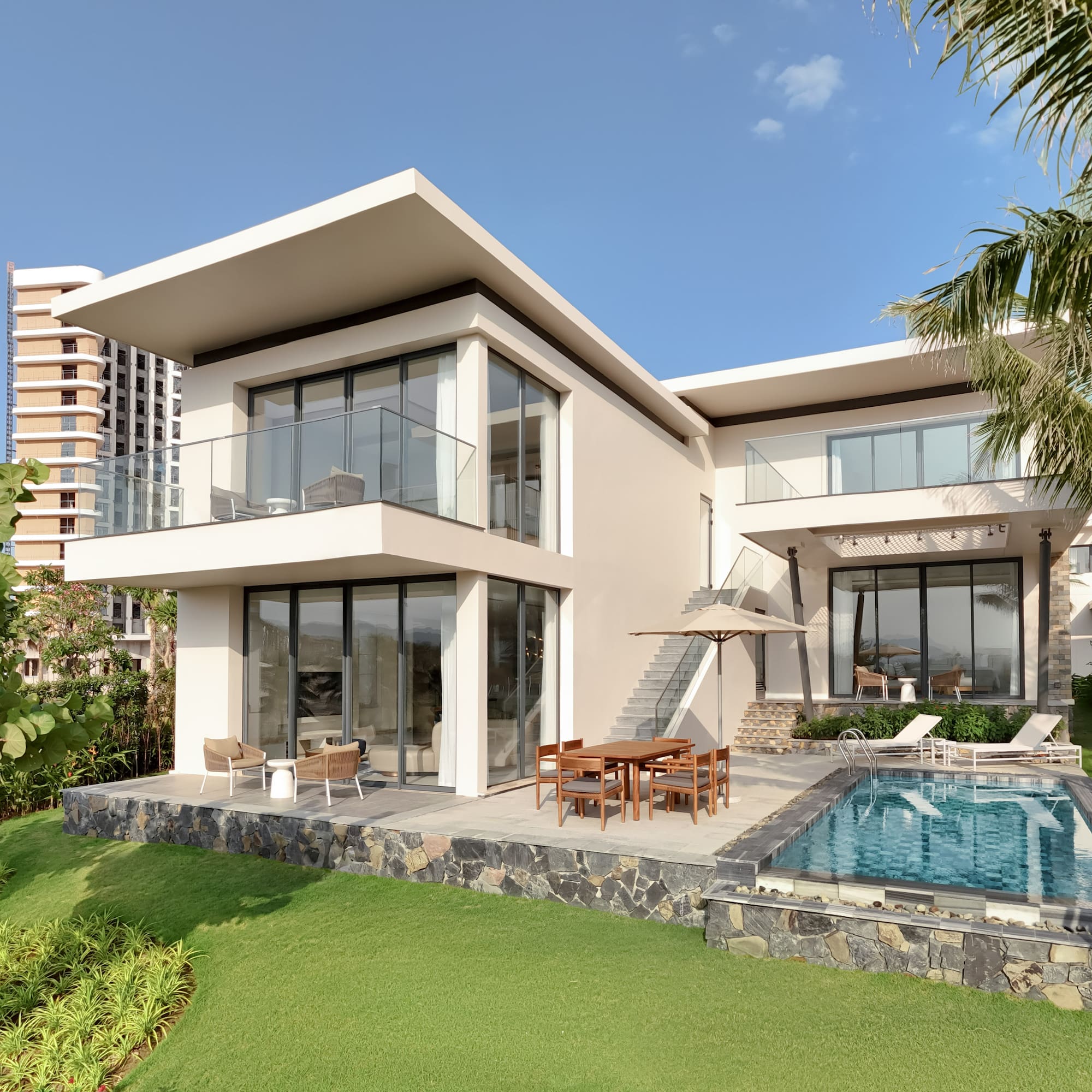 Luxury modern villa with private pool and tropical landscaping.