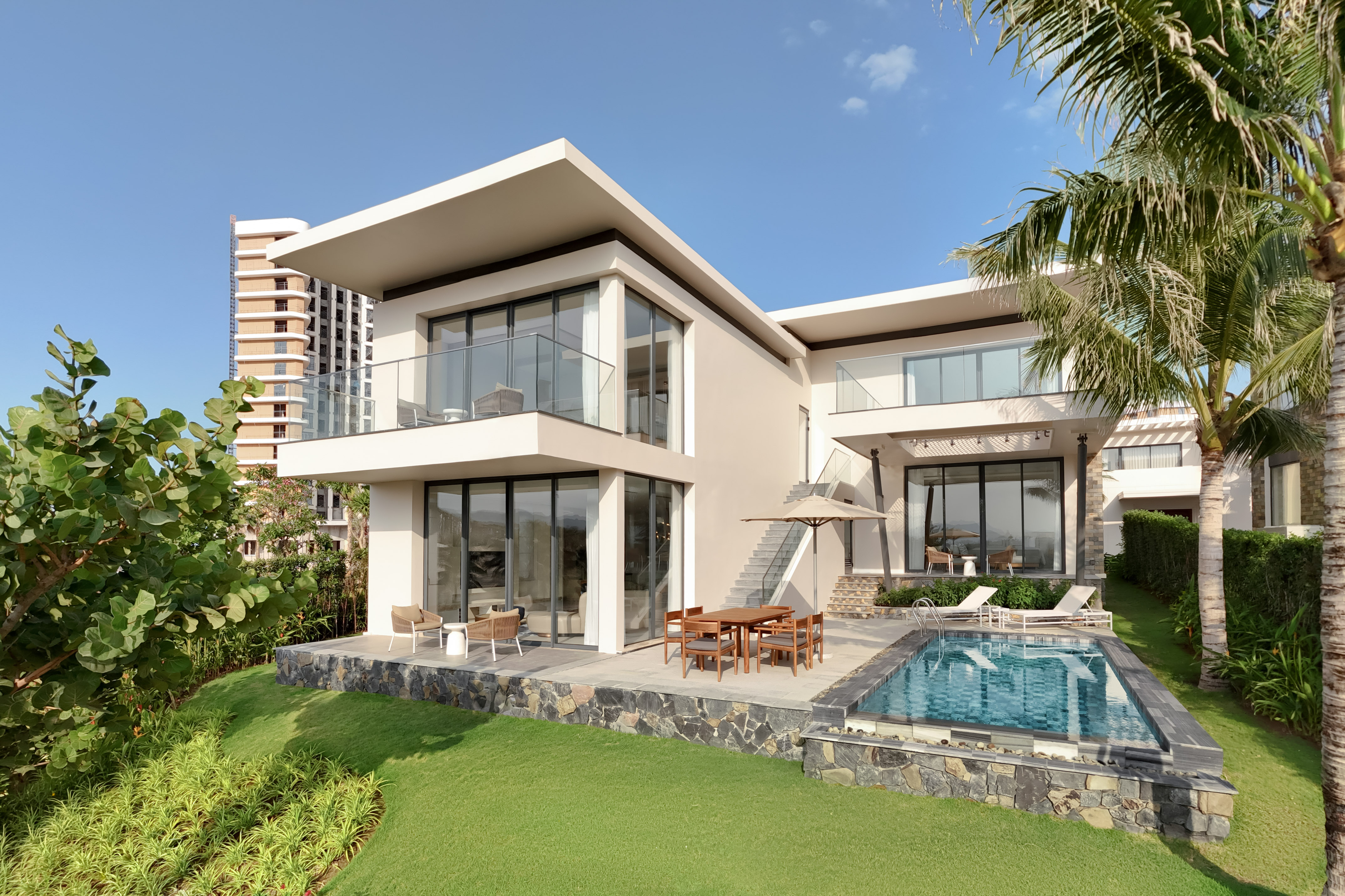 Luxury modern villa with private pool and tropical landscaping.