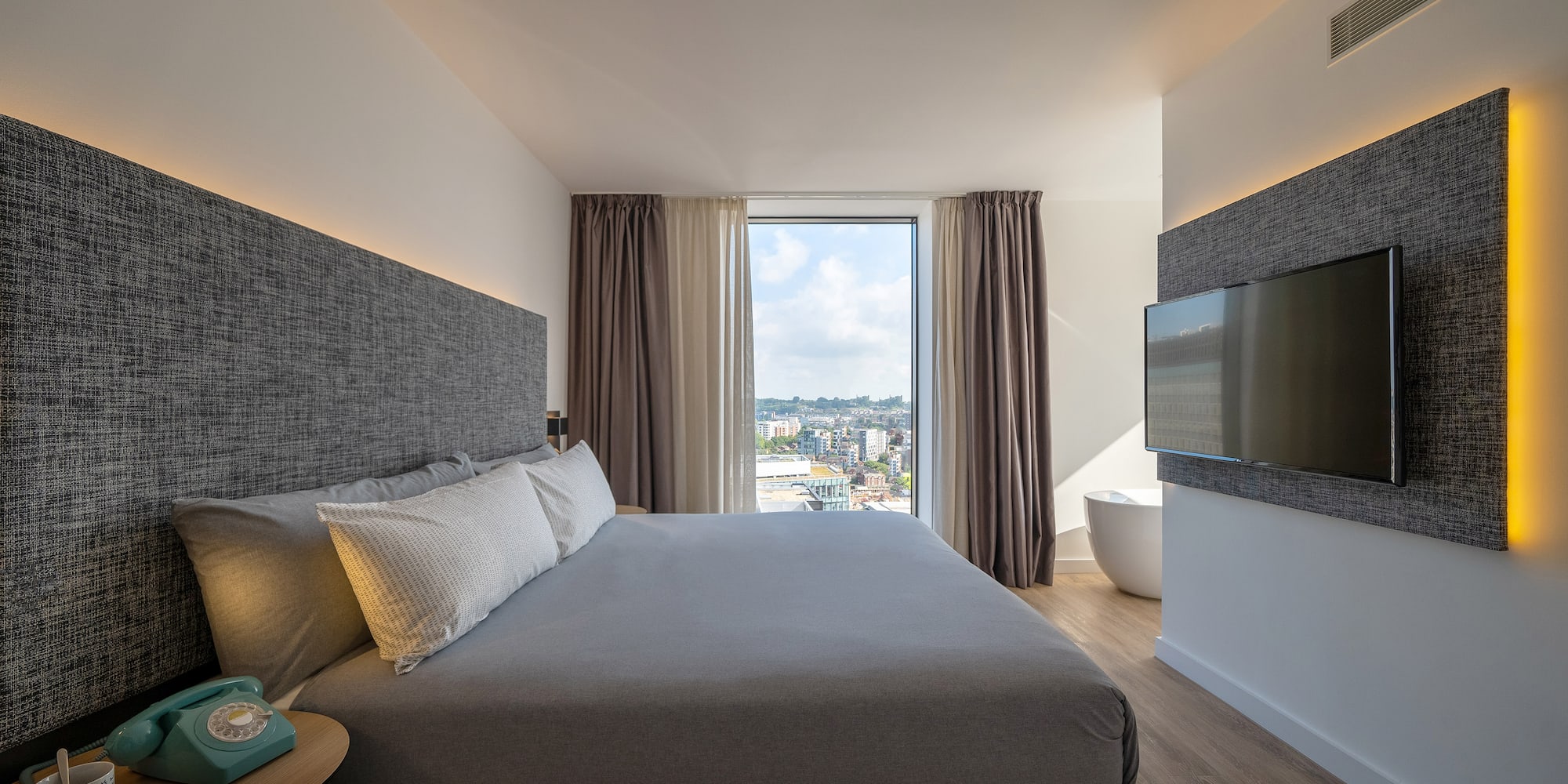 a bedroom with a large bed and a television