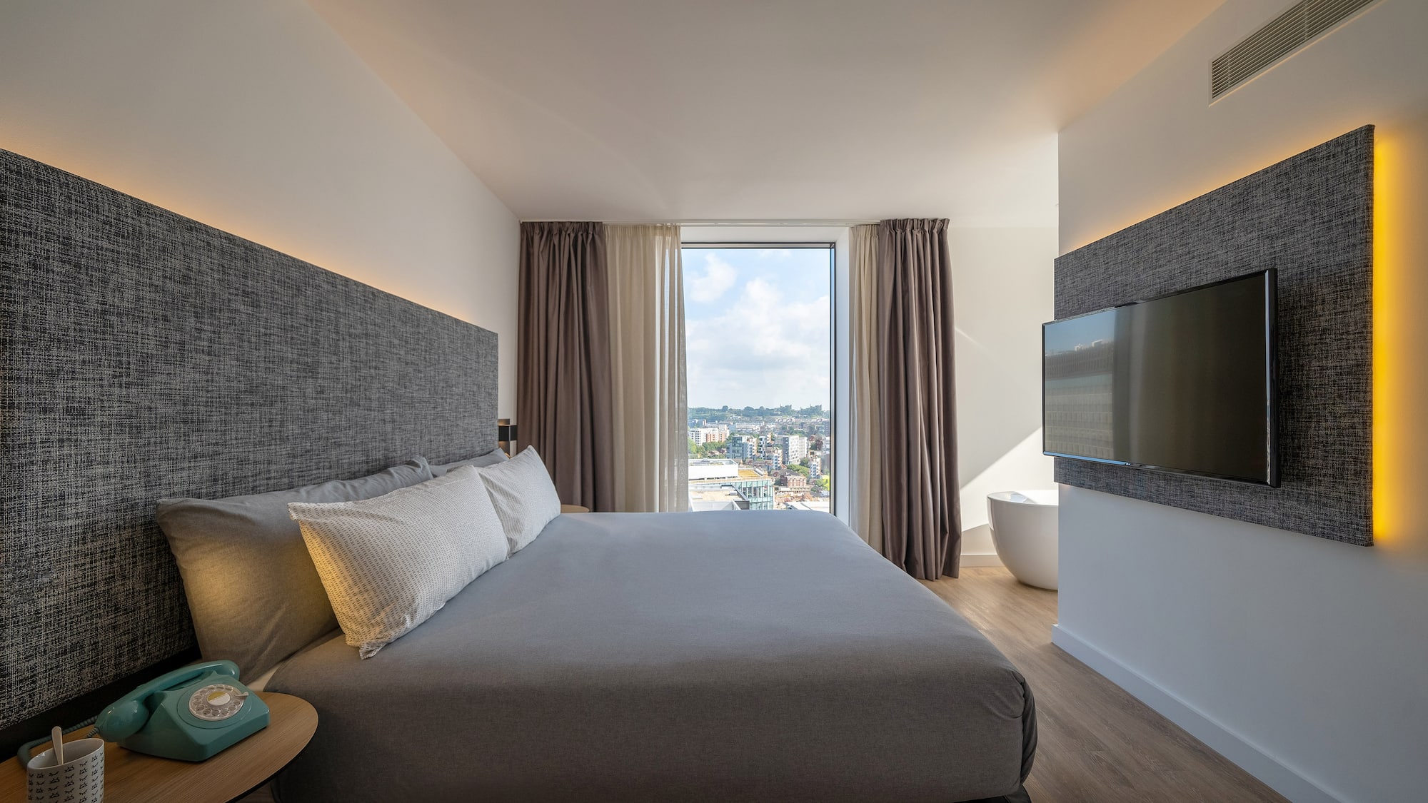 a bedroom with a large bed and a television