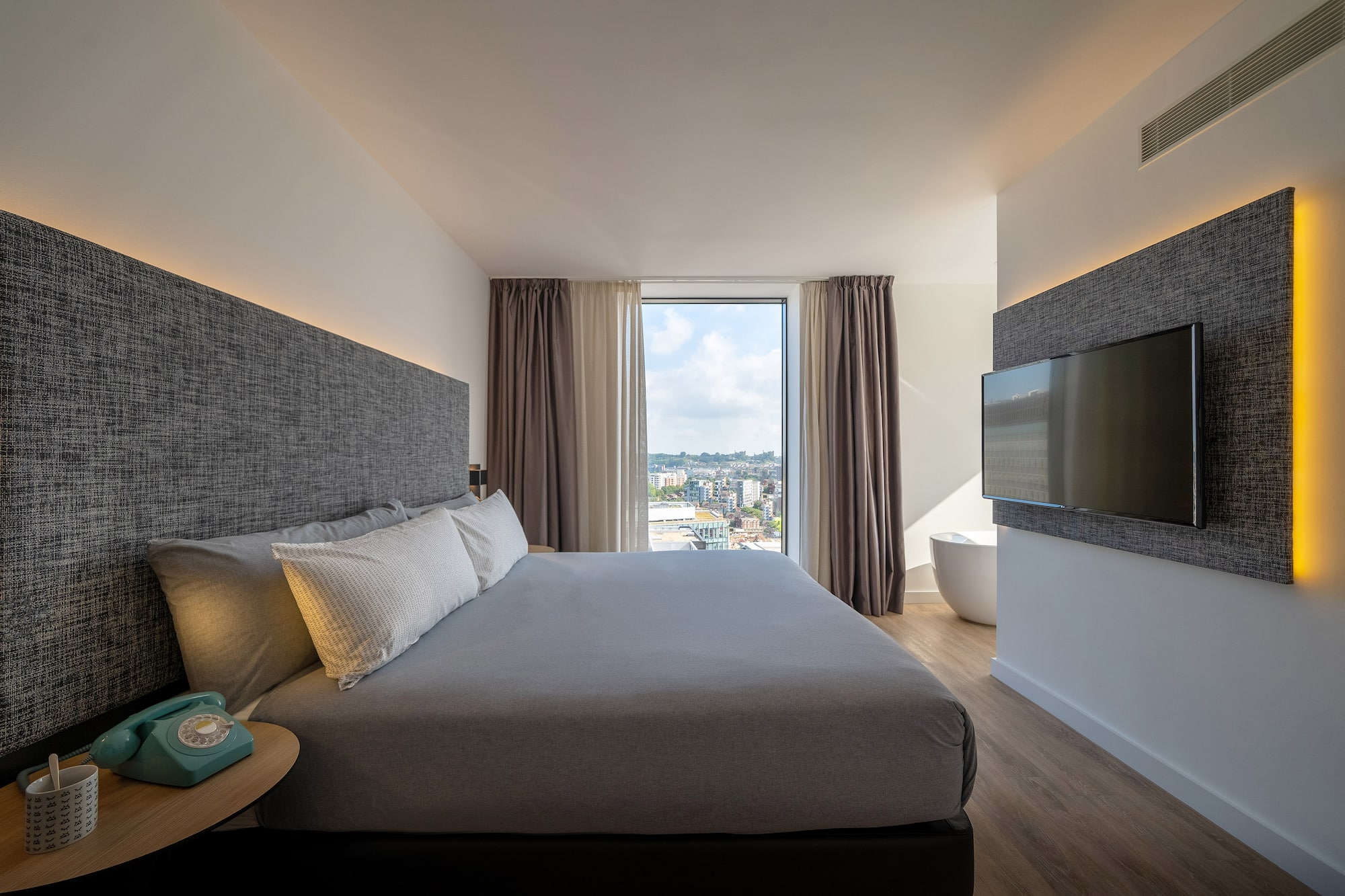 a bedroom with a large bed and a television