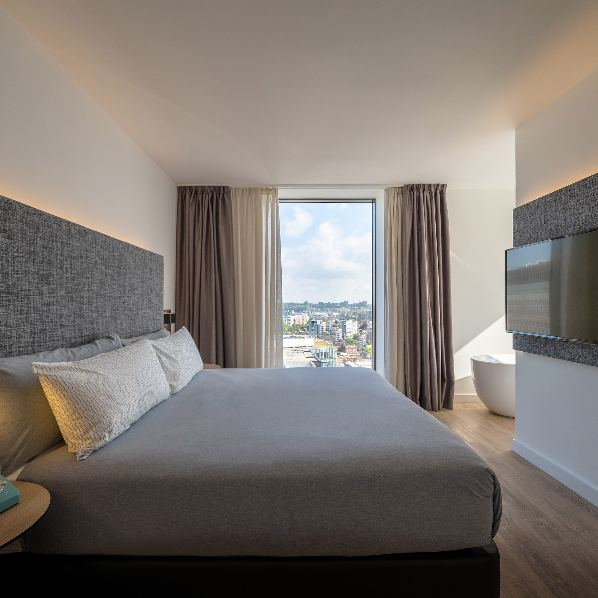 a bedroom with a large bed and a television