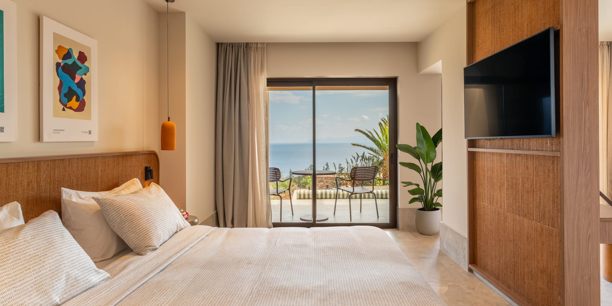 a bedroom with a large window and a large bed