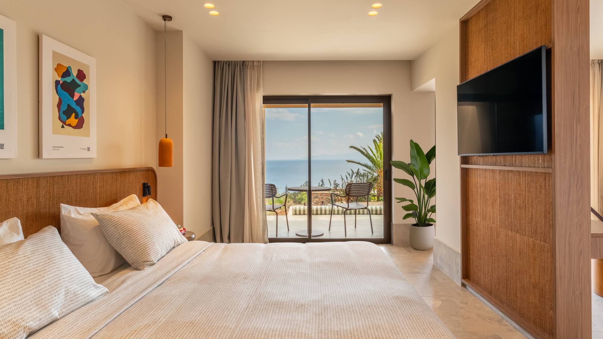 a bedroom with a large window and a large bed