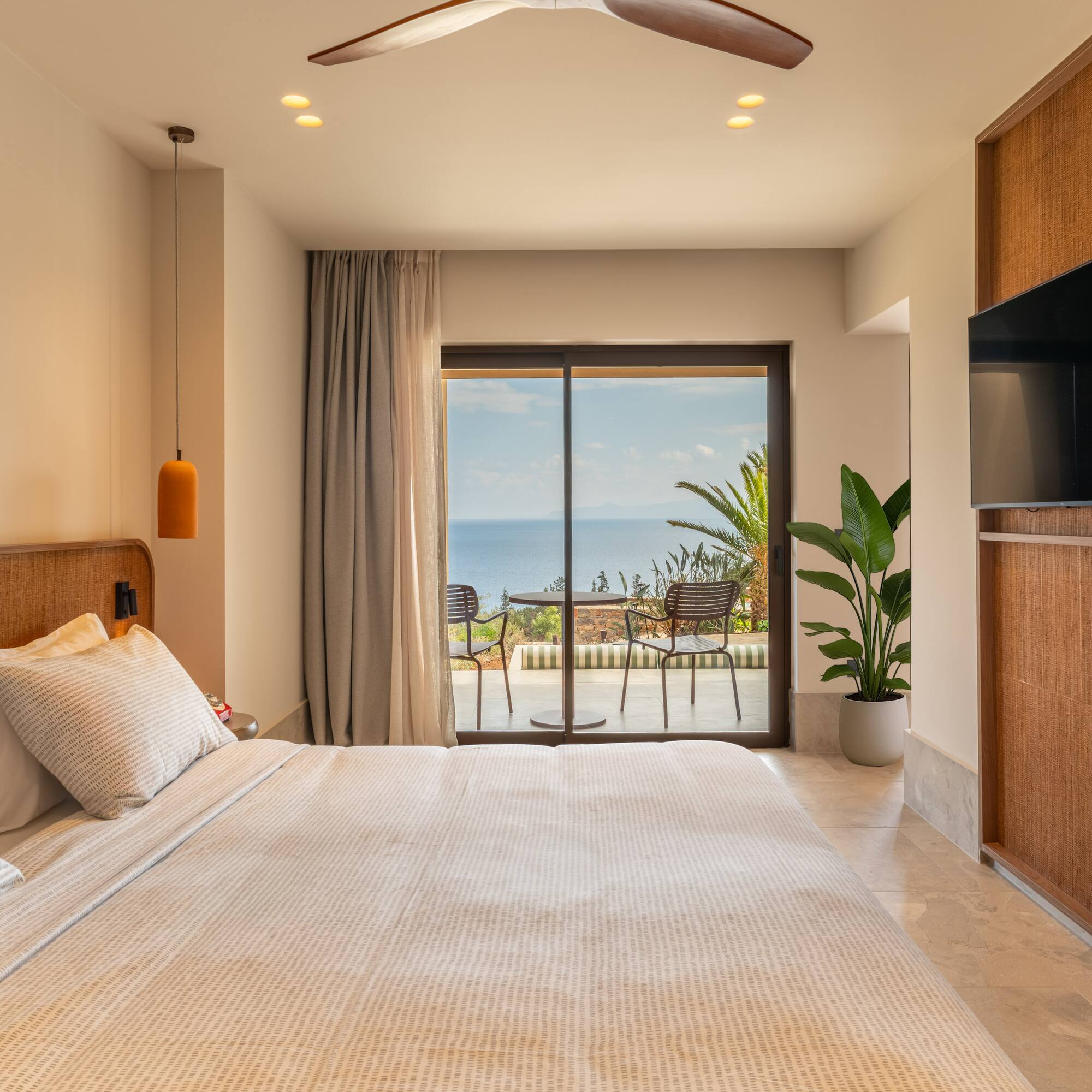 a bedroom with a large window and a large bed