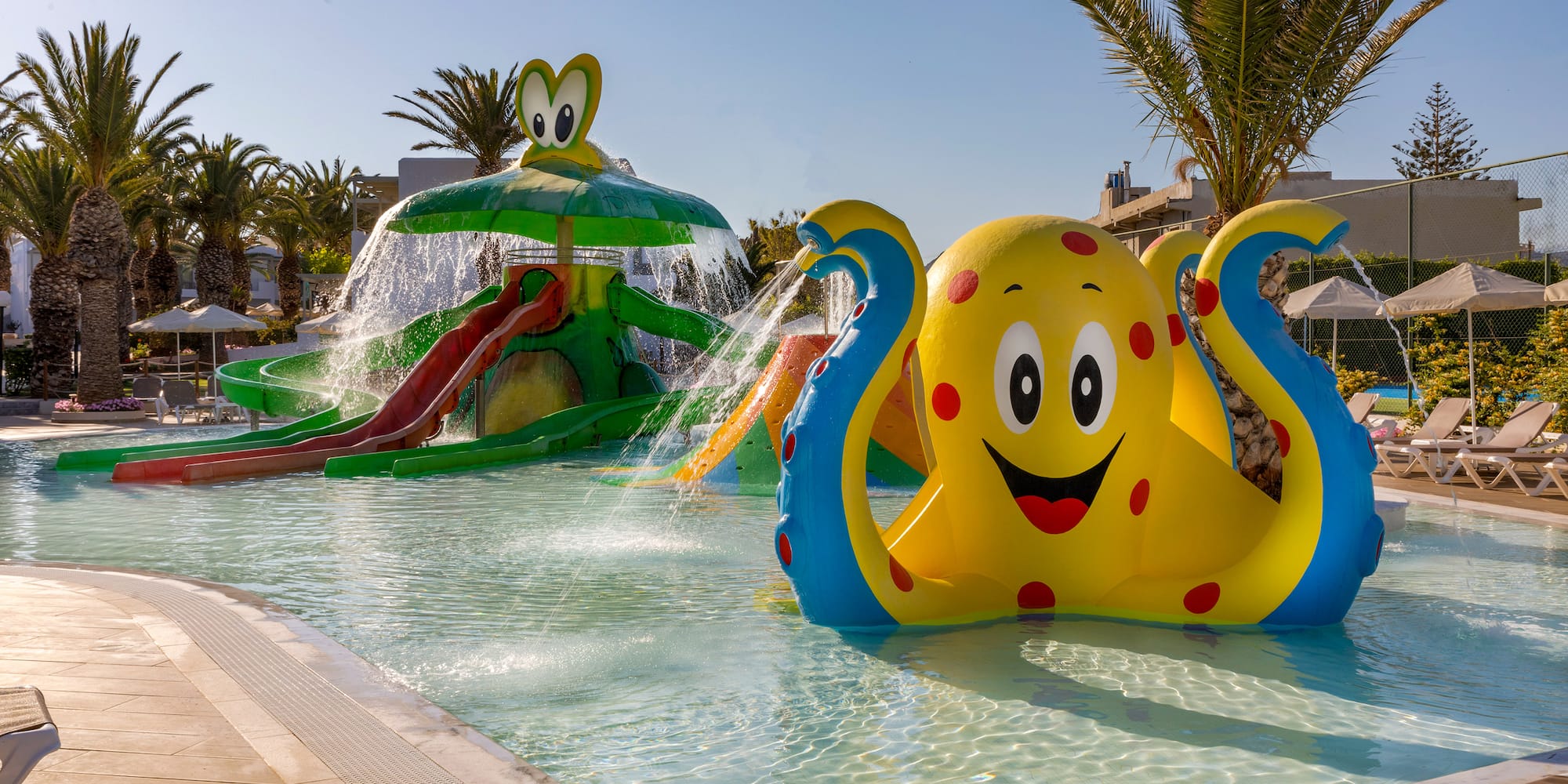 a water park with an inflatable octopus and a slide