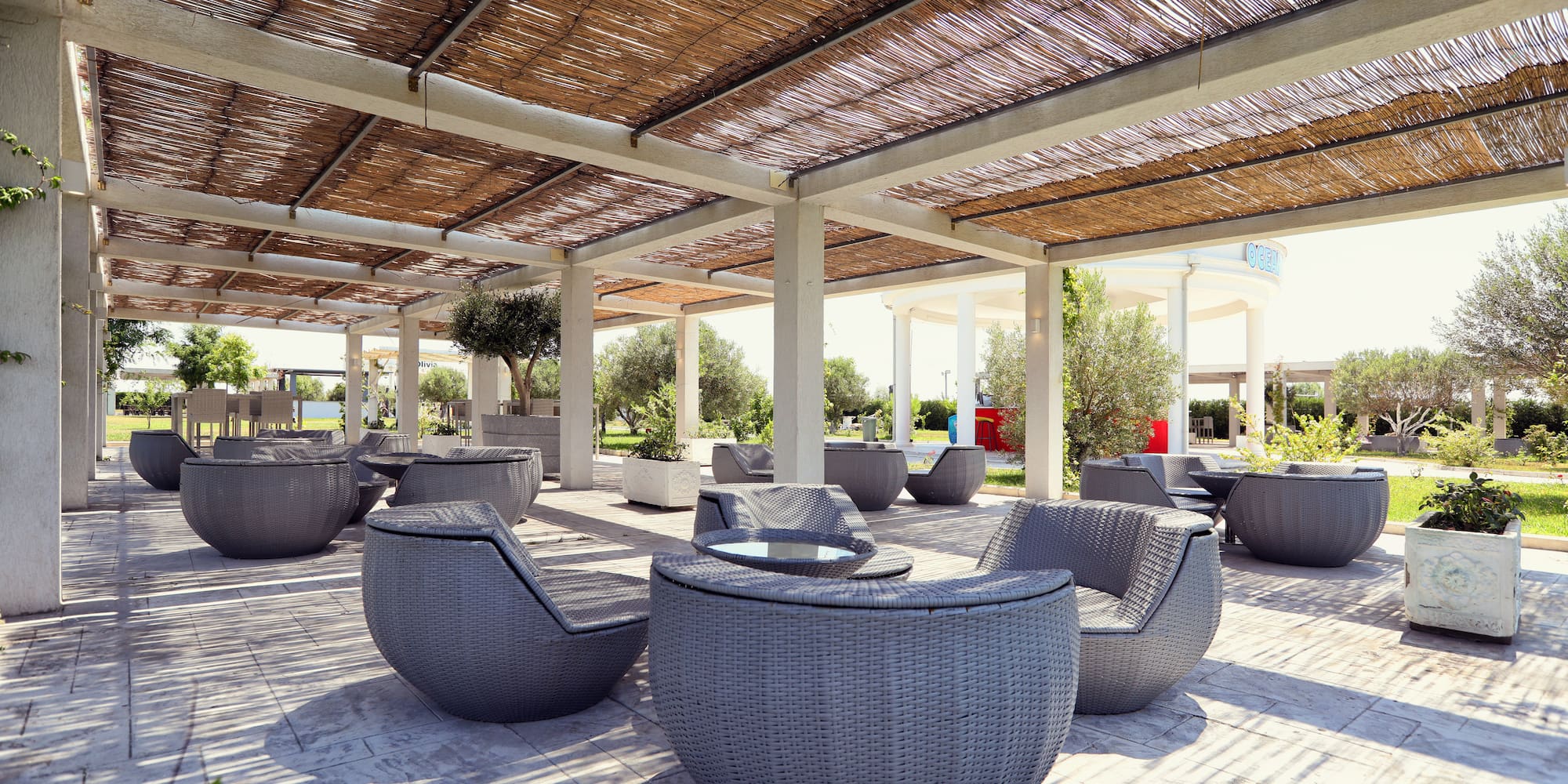 a patio with chairs and tables