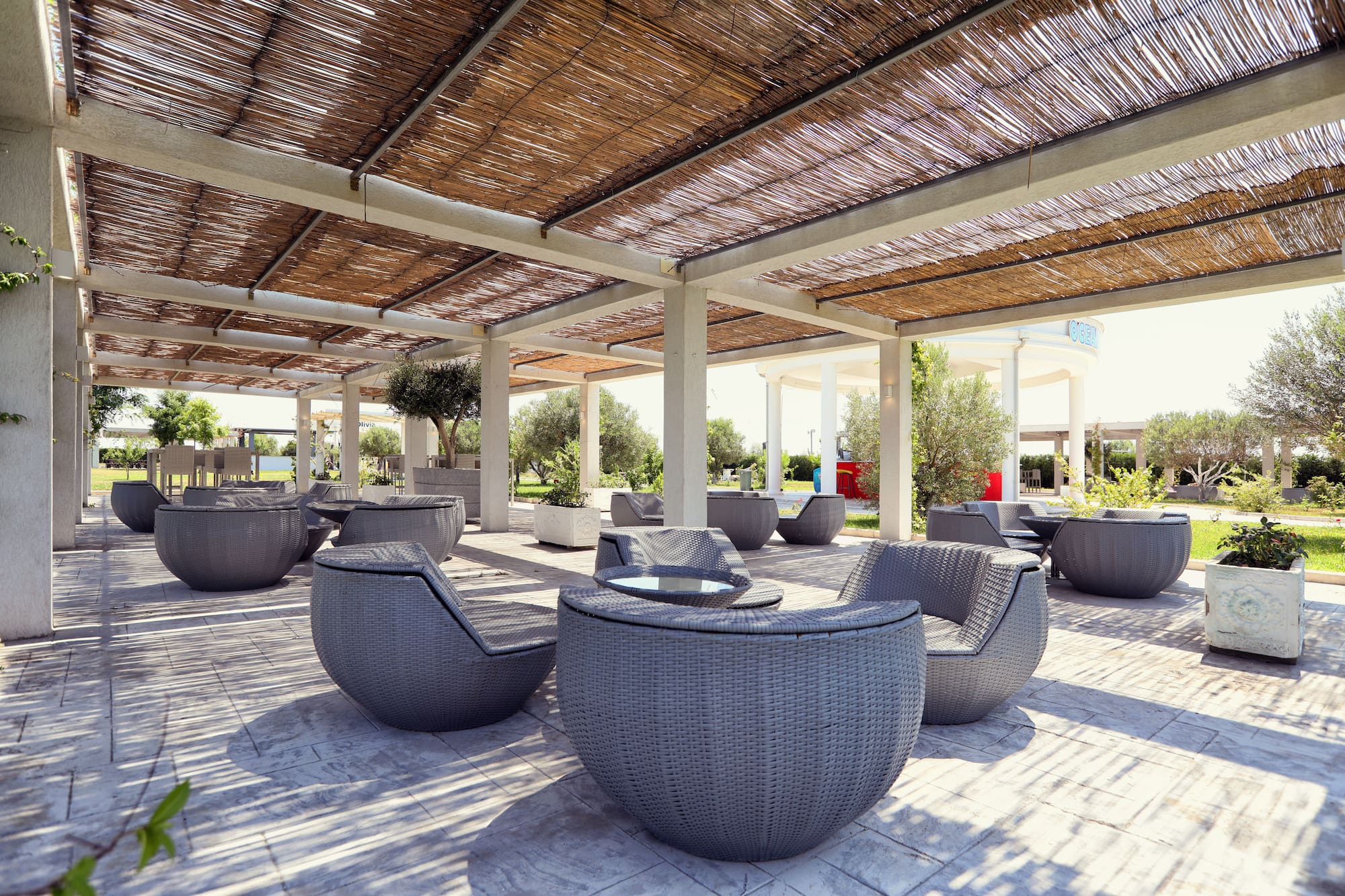 a patio with chairs and tables