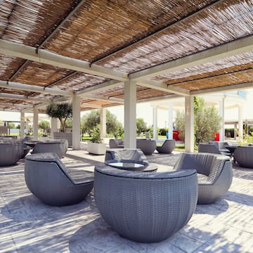 a patio with chairs and tables