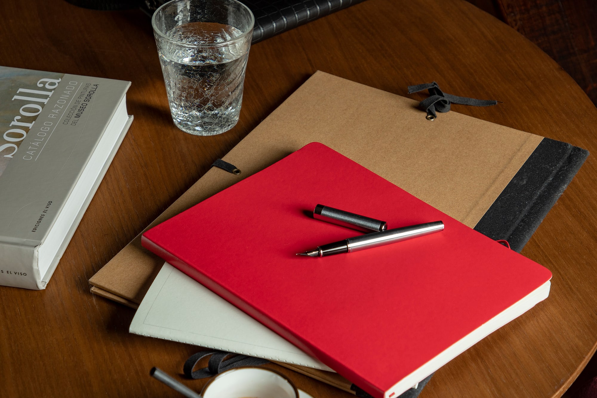 a table with a cup of coffee and books