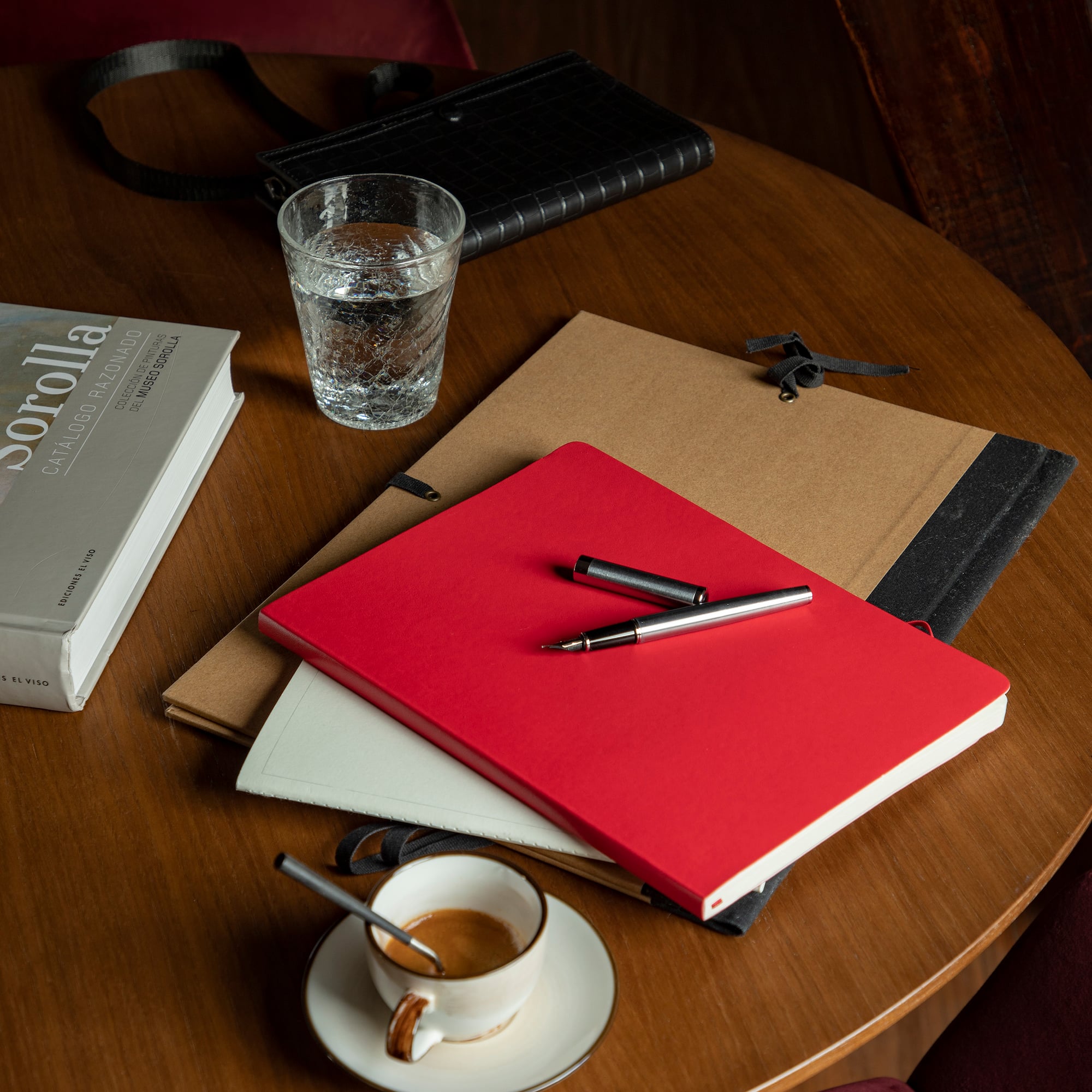 a table with a cup of coffee and books