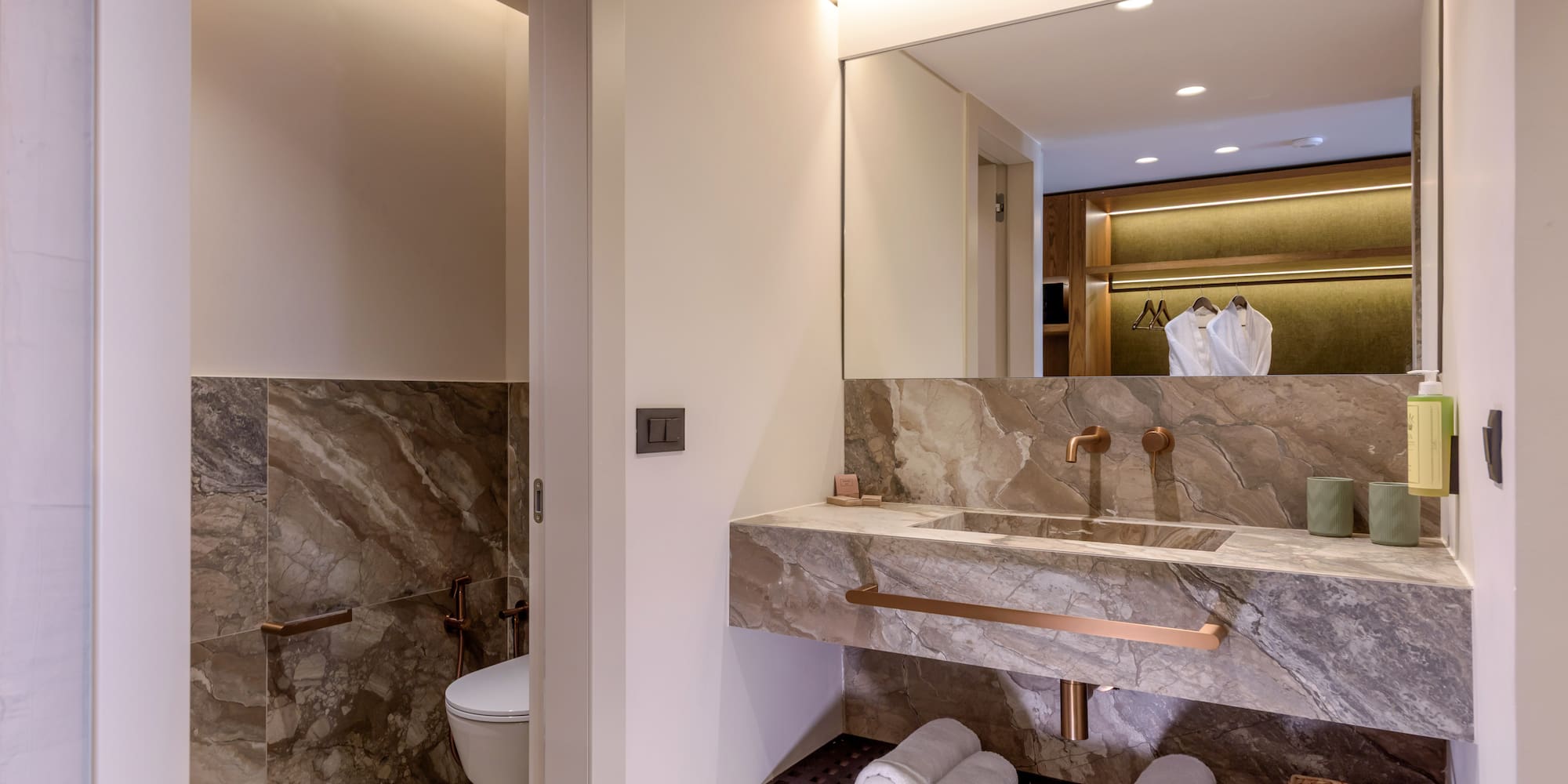 a bathroom with marble countertop and sink.