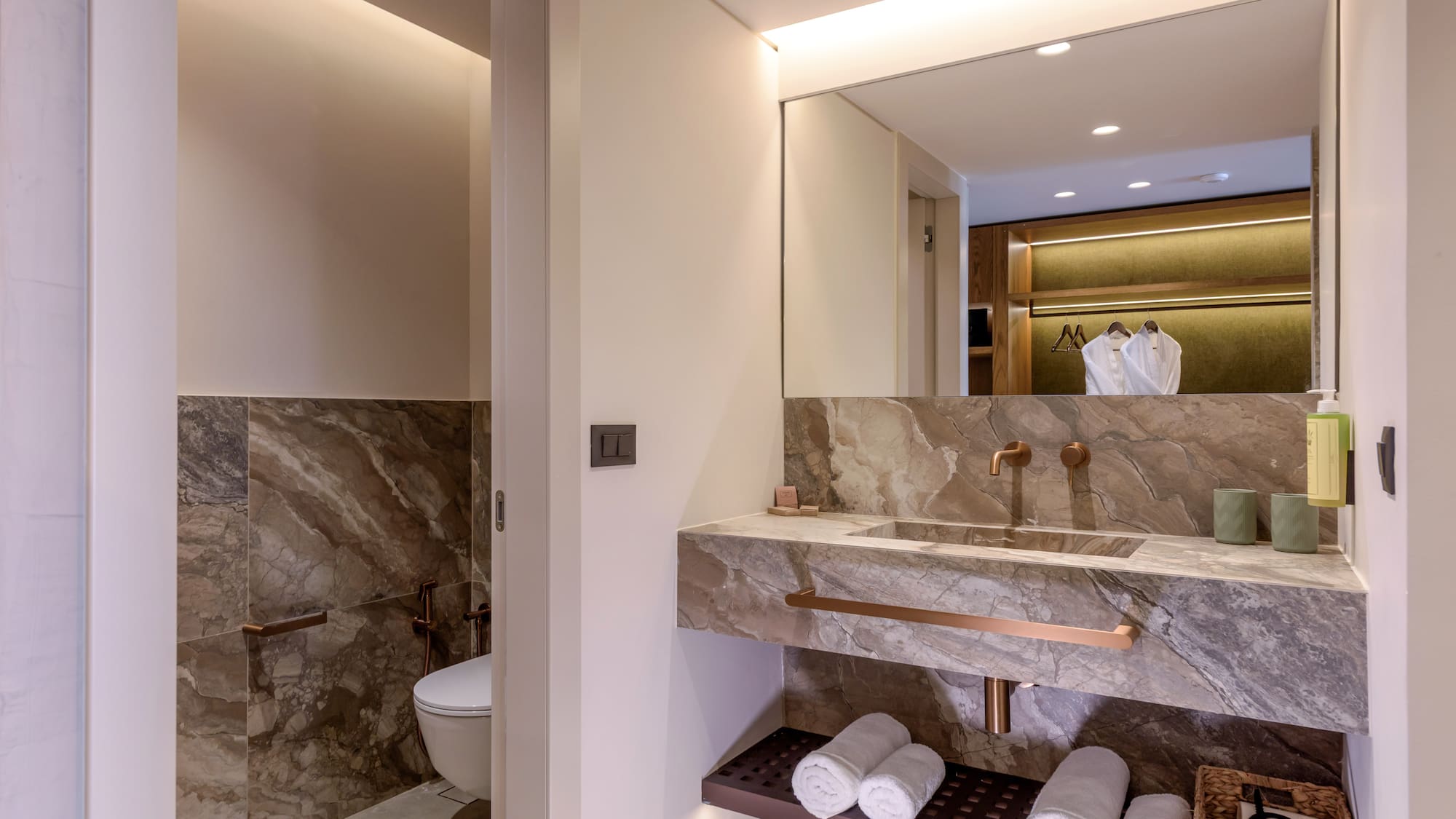 a bathroom with marble countertop and sink.