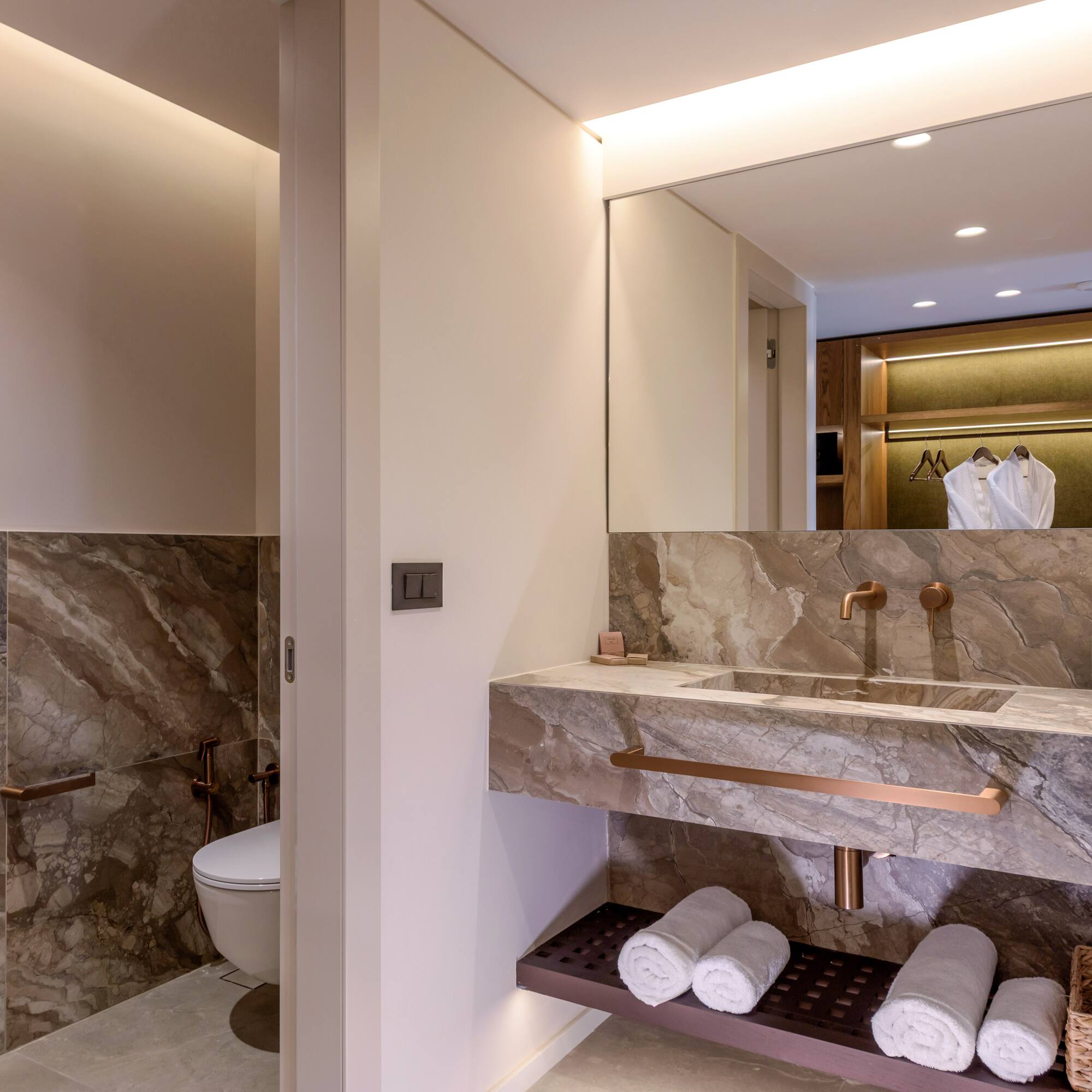 a bathroom with marble countertop and sink.