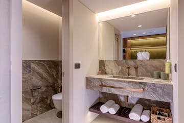 a bathroom with marble countertop and sink.
