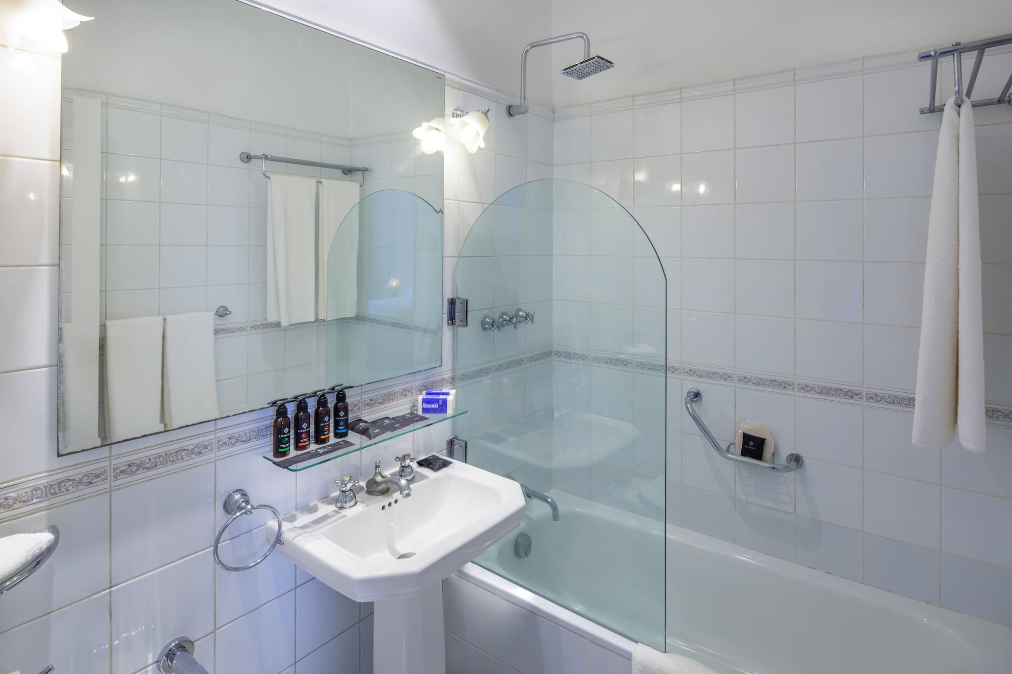 a bathroom with a glass shower door