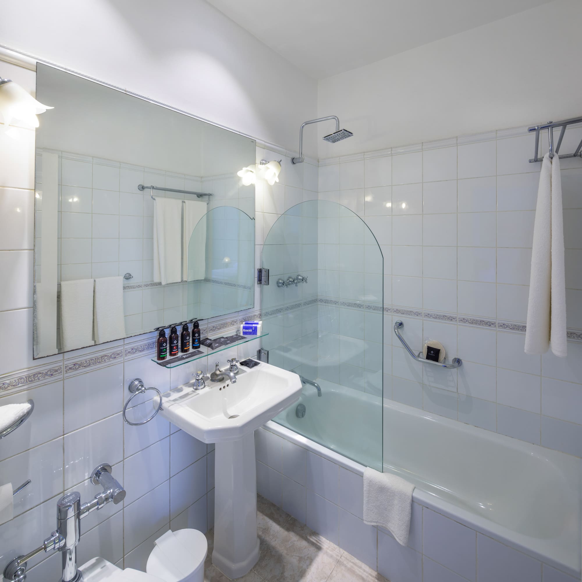 a bathroom with a glass shower door