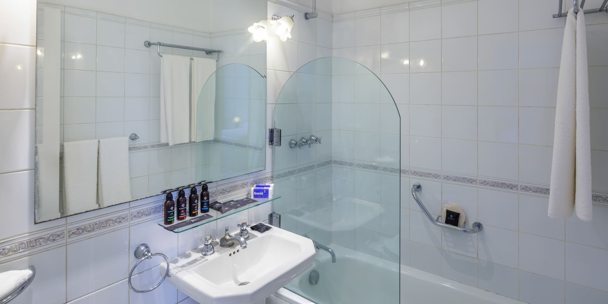 a bathroom with a glass shower door