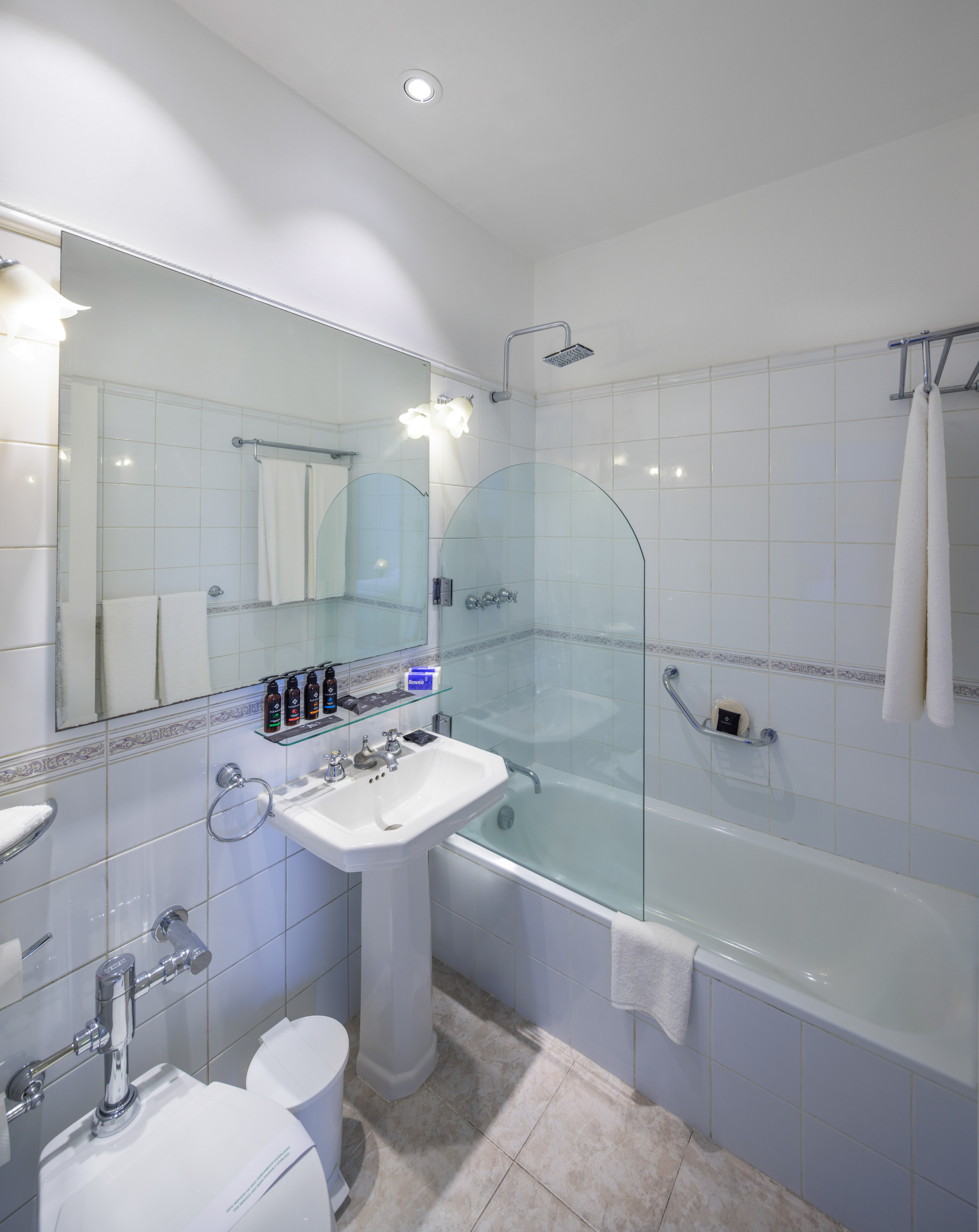 a bathroom with a glass shower door