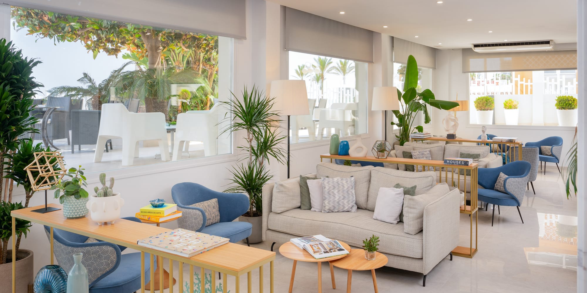 a room with couches and tables and chairs