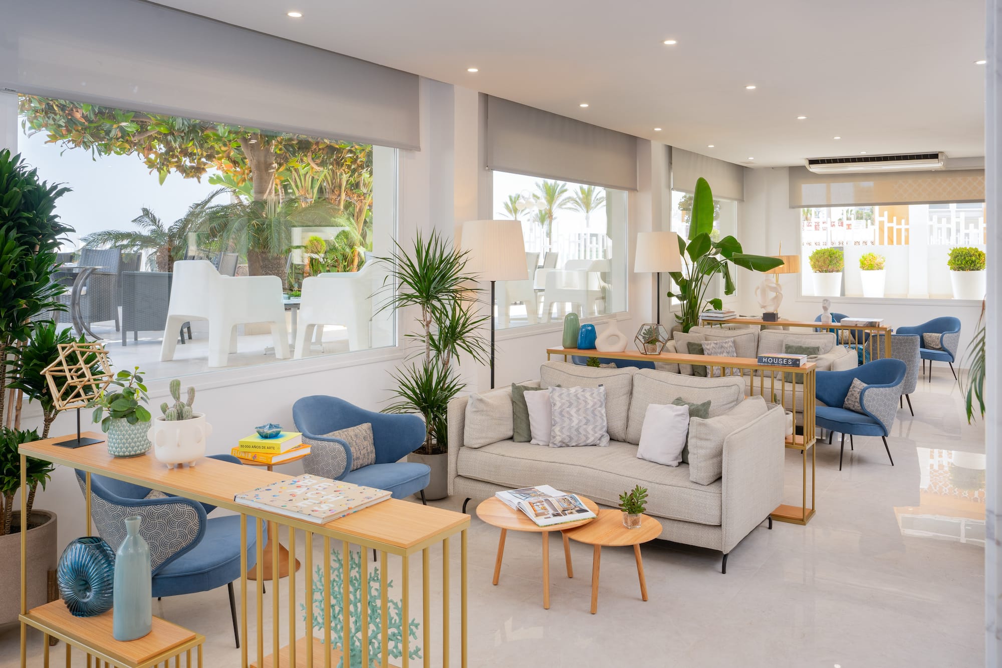 a room with couches and tables and chairs