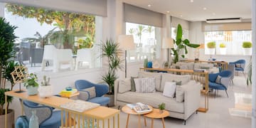 a room with couches and tables and chairs