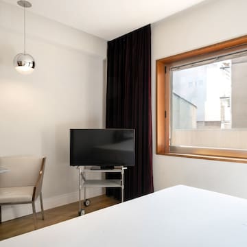 a room with a tv and a chair