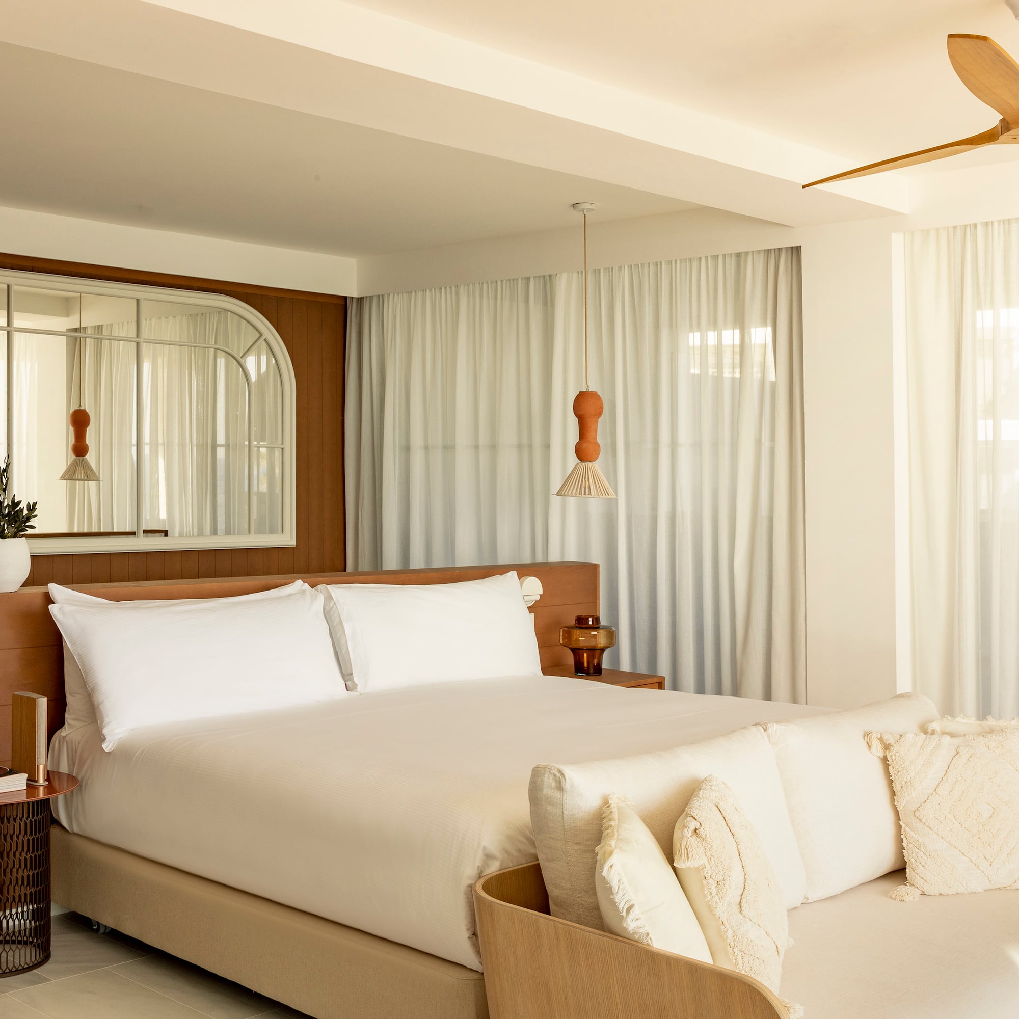 a bedroom with a bed and a fan