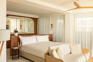 a bedroom with a bed and a fan