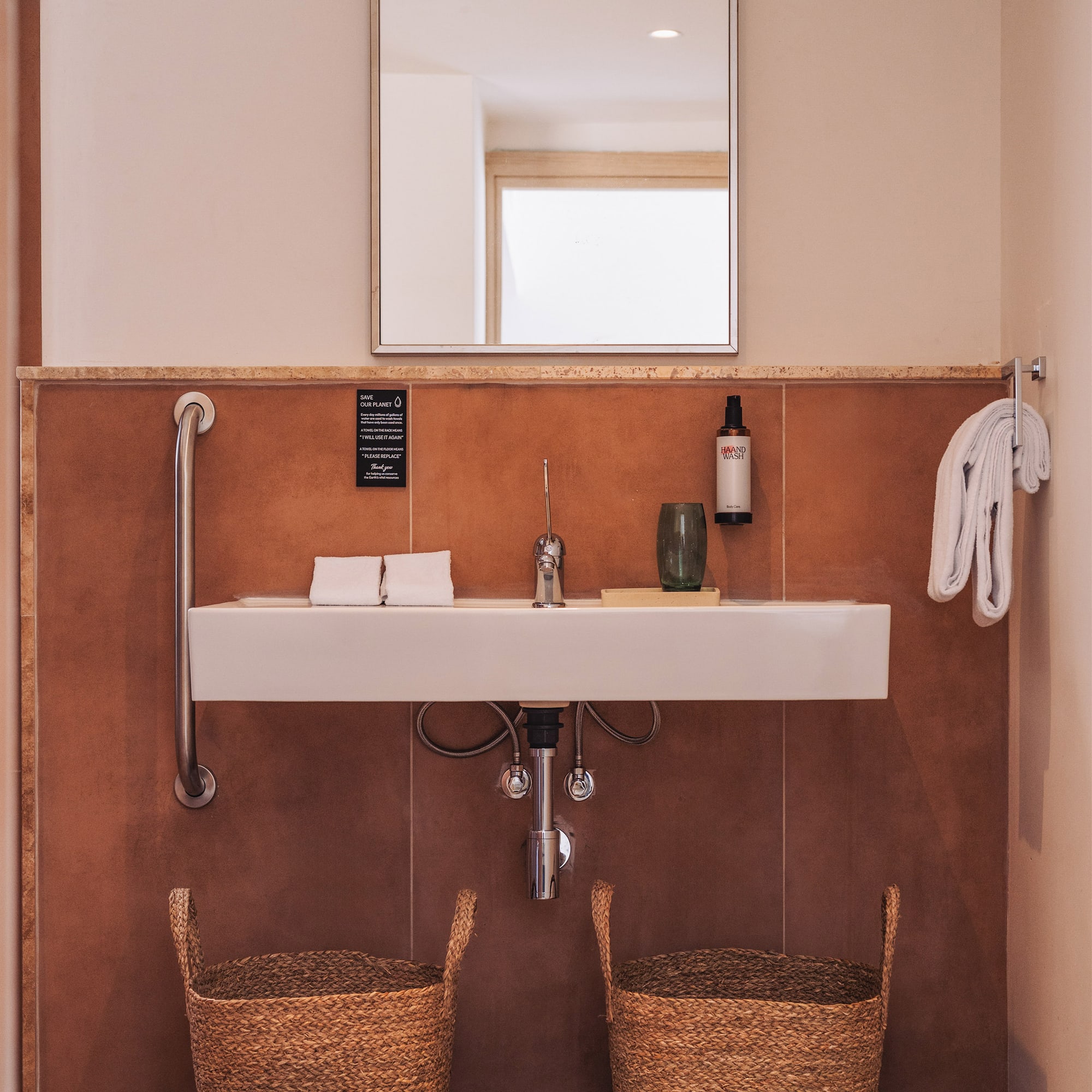 a bathroom with a sink and two baskets