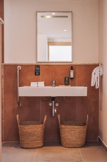 a bathroom with a sink and two baskets