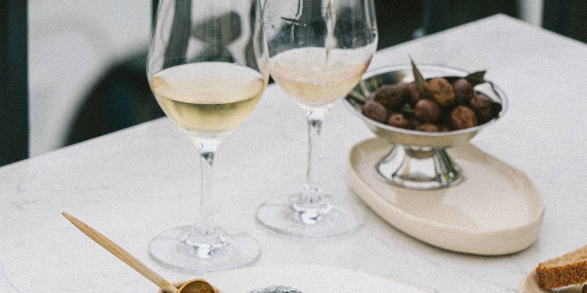 a plate of food and a glass of wine