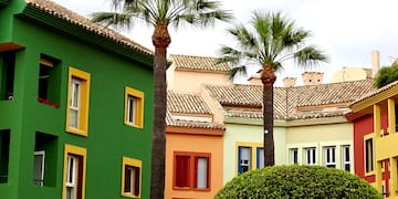 a row of colorful buildings with palm trees