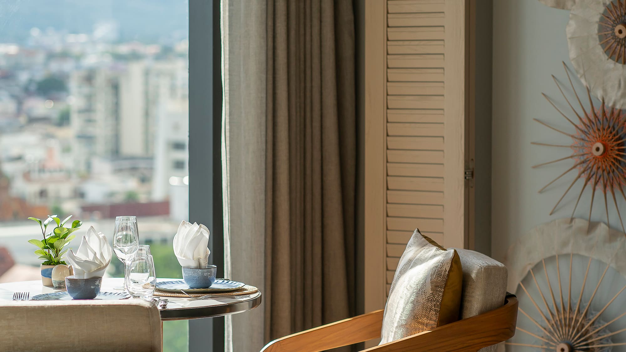 a room with a table and chairs and a window