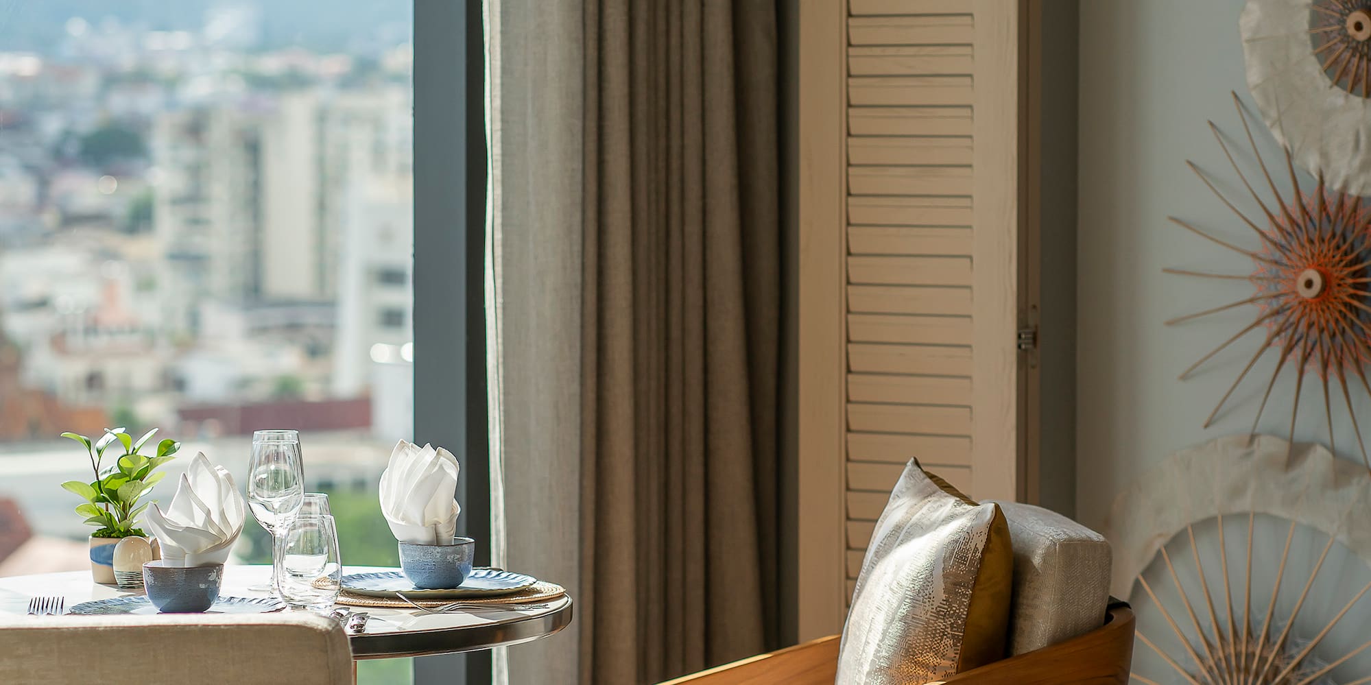 a room with a table and chairs and a window