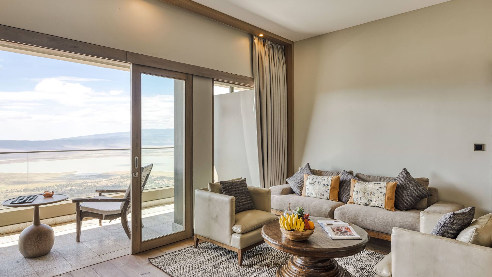 a living room with a glass door and a couch