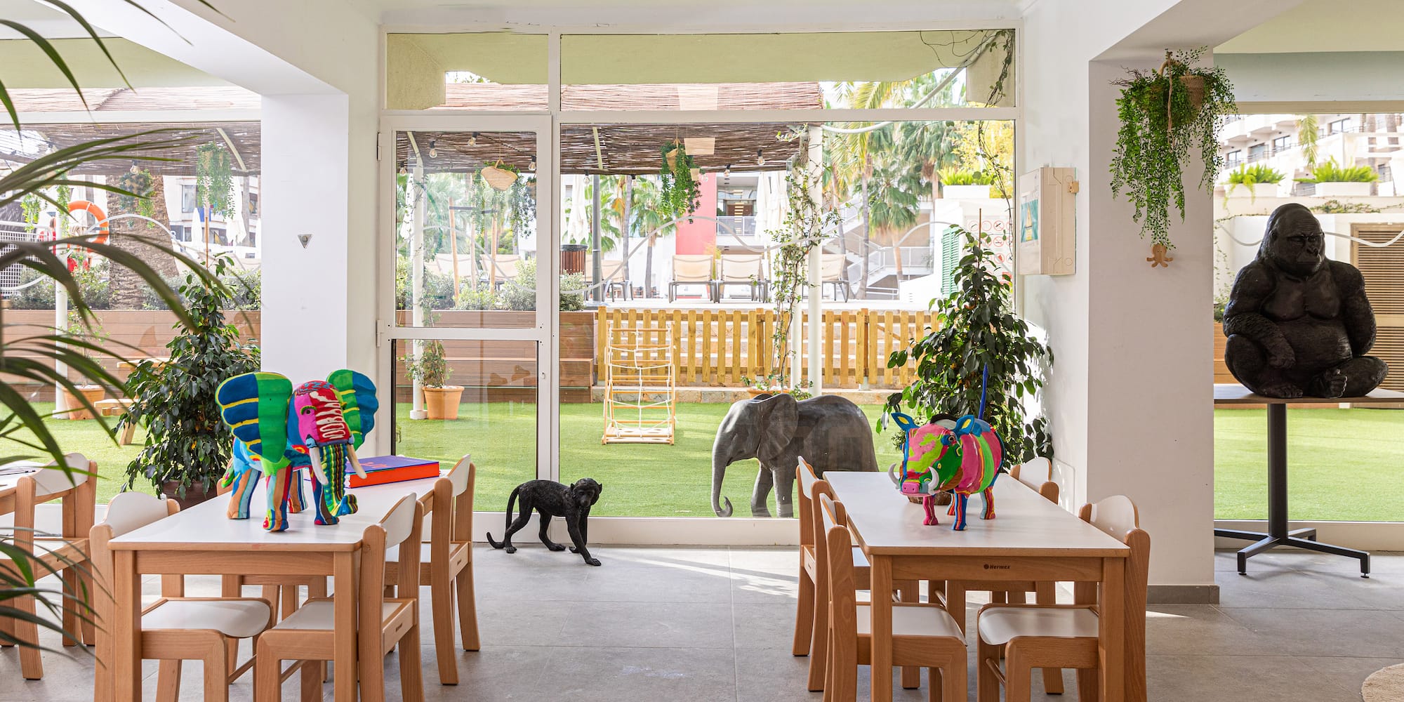 a room with tables and chairs and a dog outside