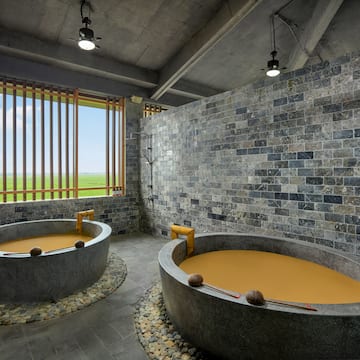 a large stone tubs with orange liquid in it