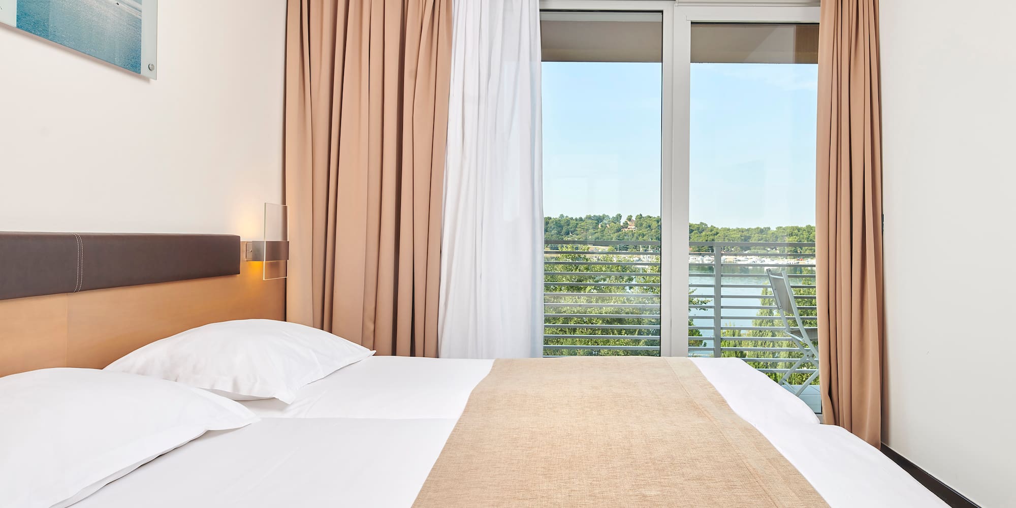 a bed with a window and curtains