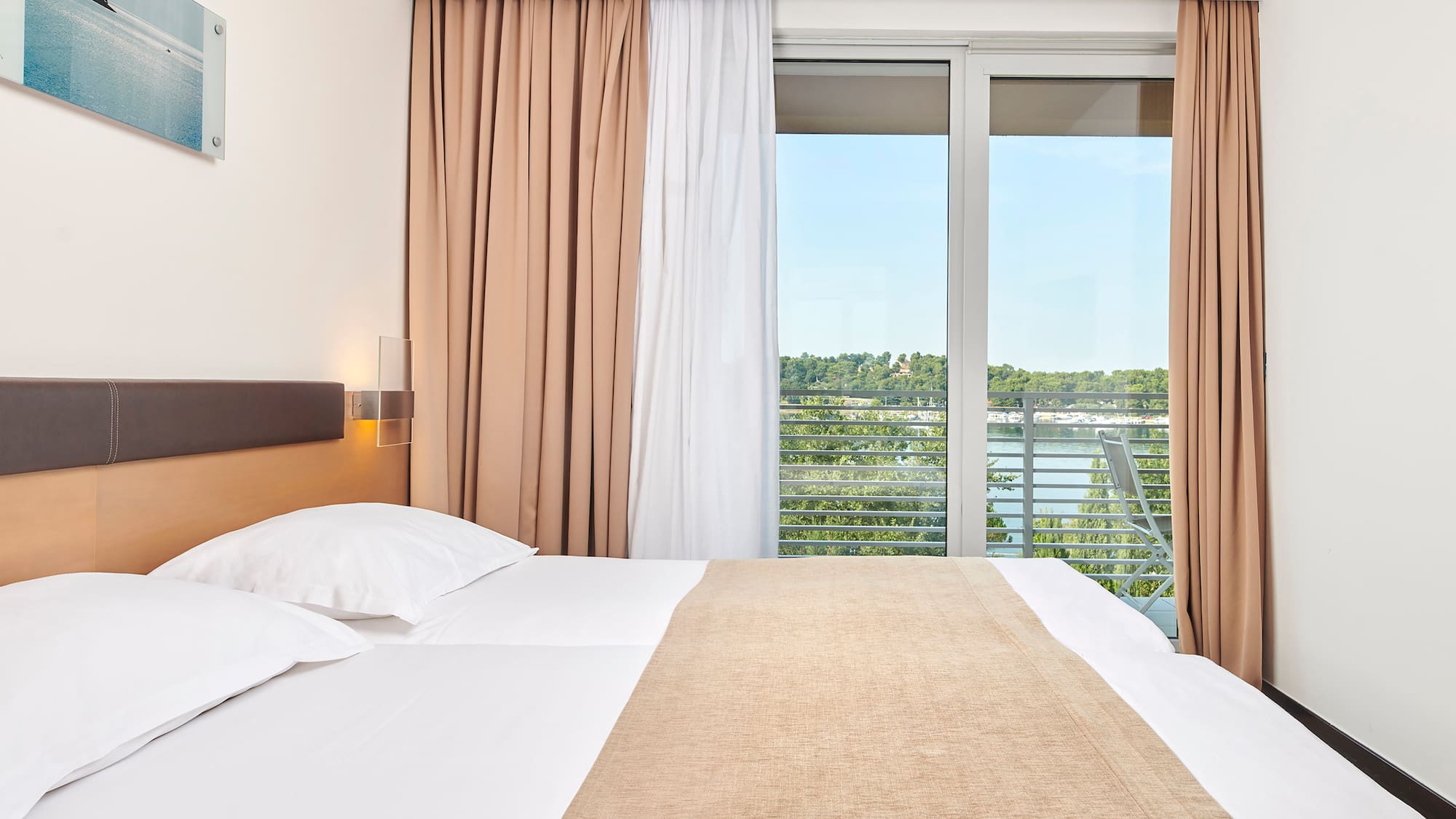 a bed with a window and curtains